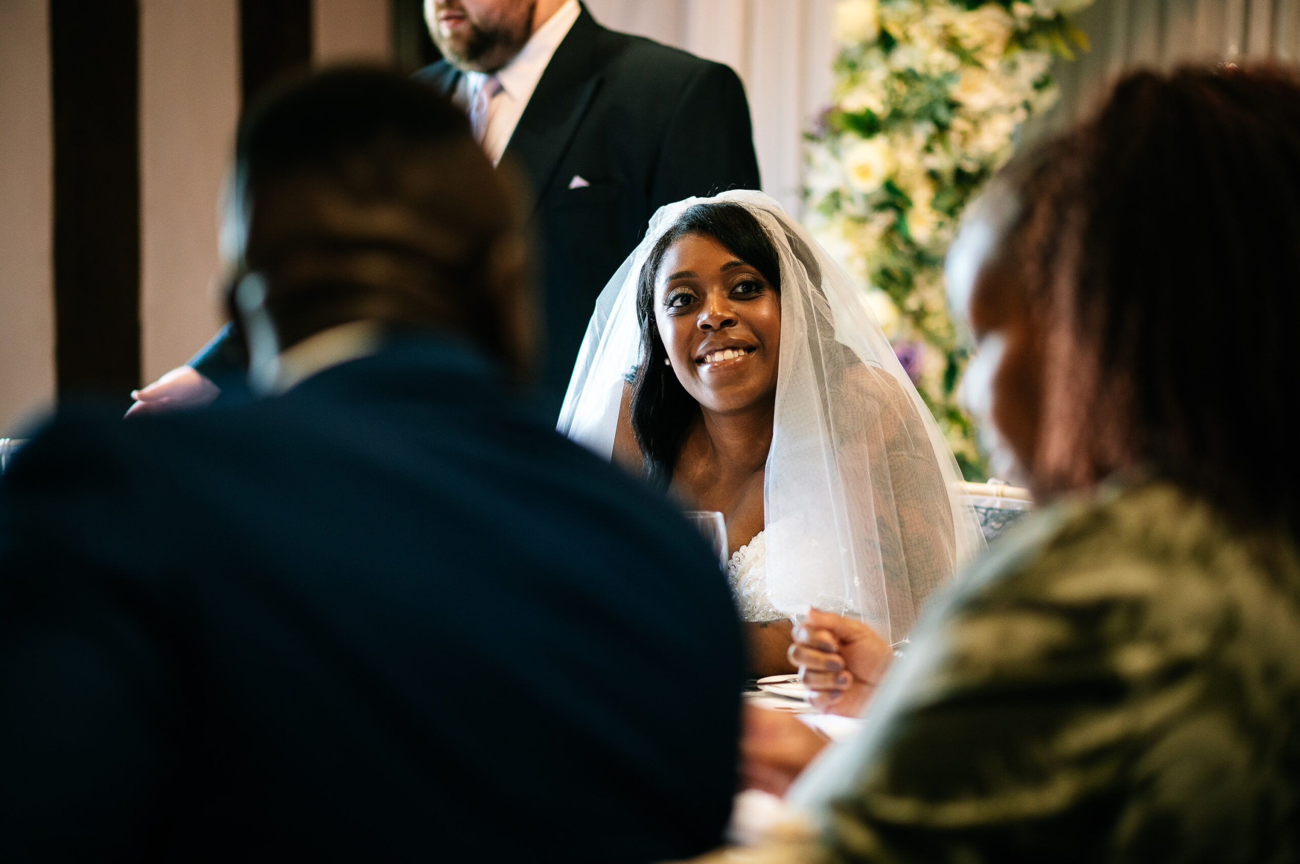 bride smiling at the guests around the table