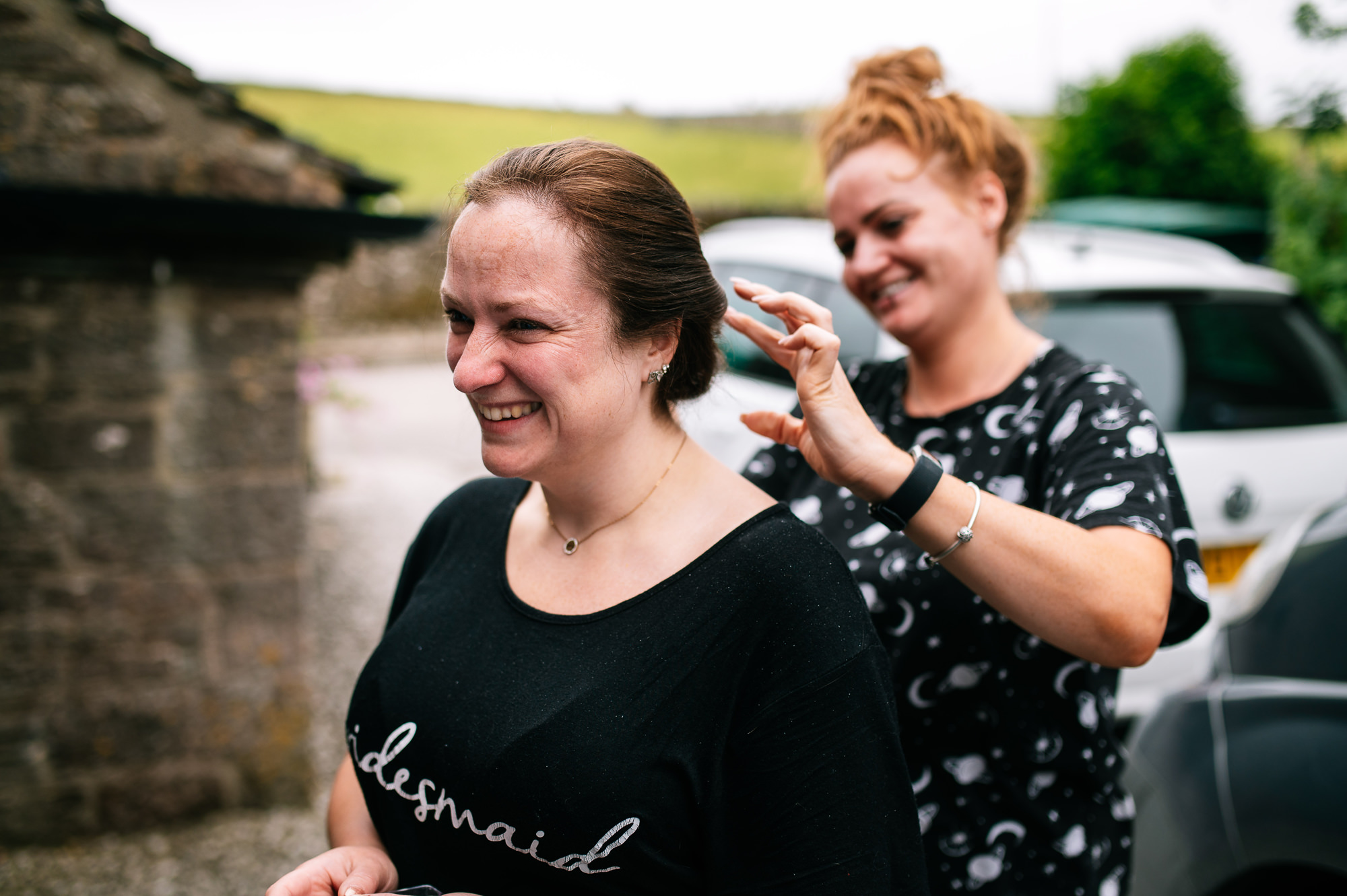 bridesmaid having her hair touched up