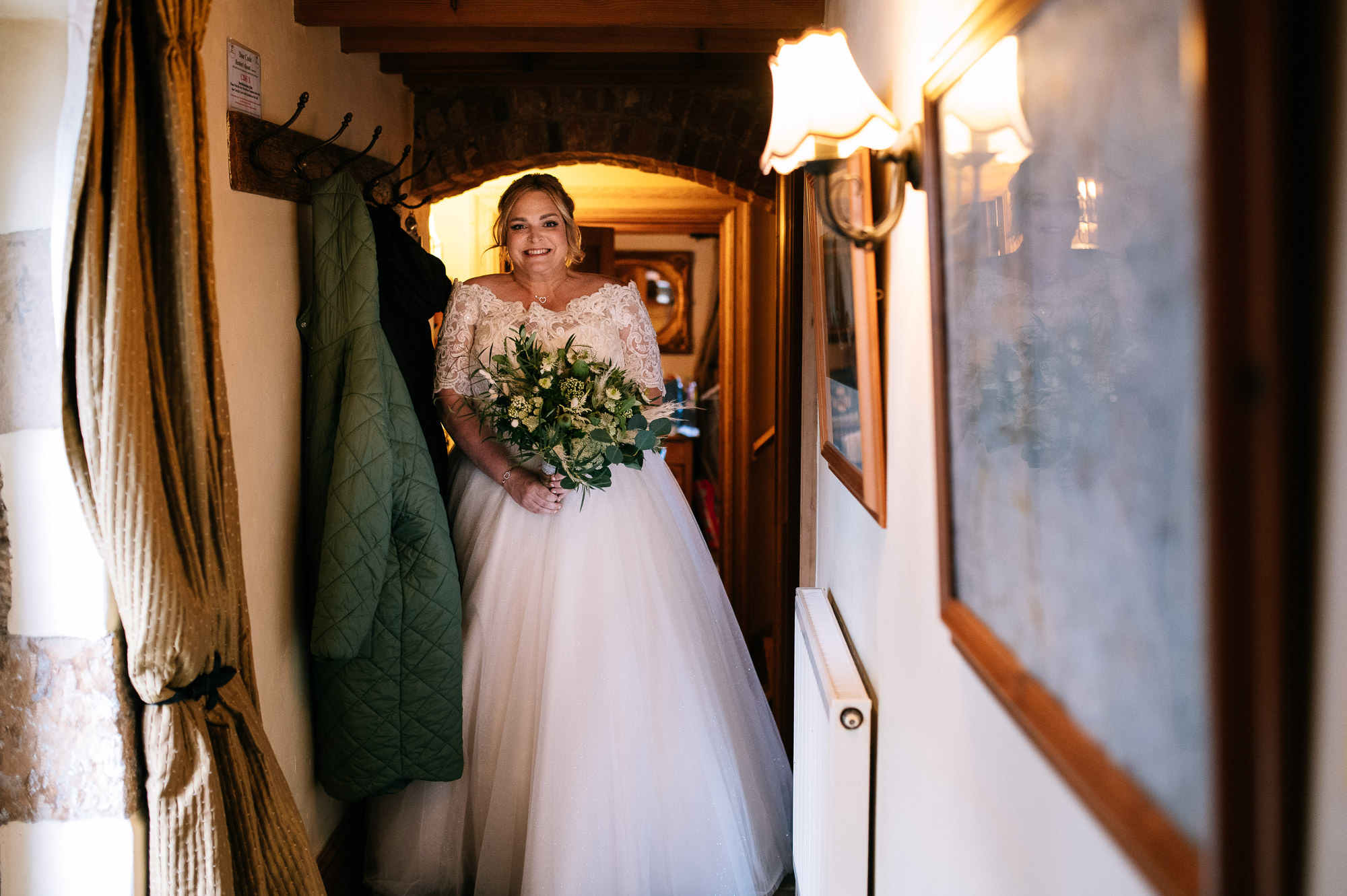 bride holding bouquet in her dress at lower damgate farm