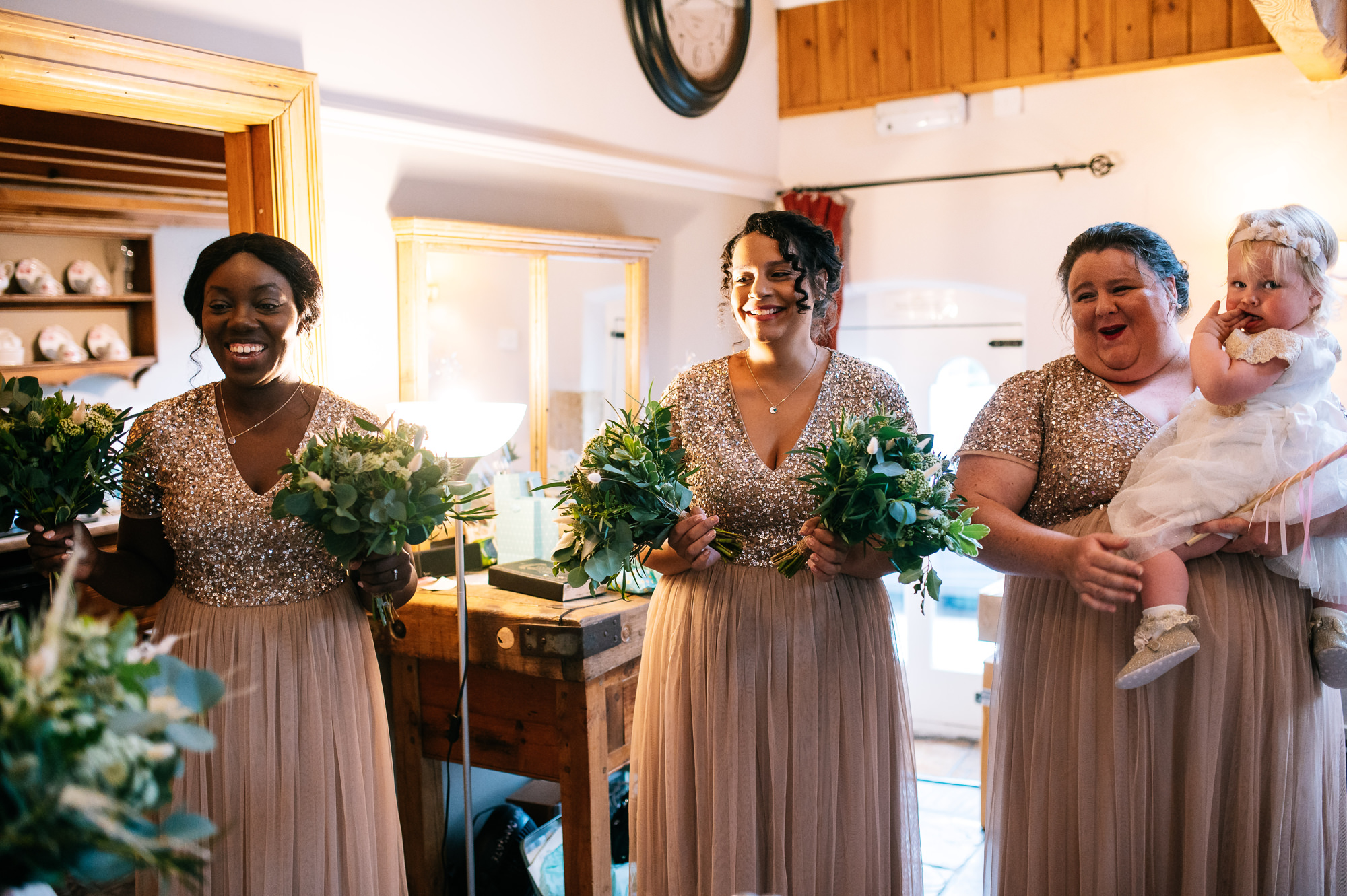 happy bridesmaids seeing the bride for the first time