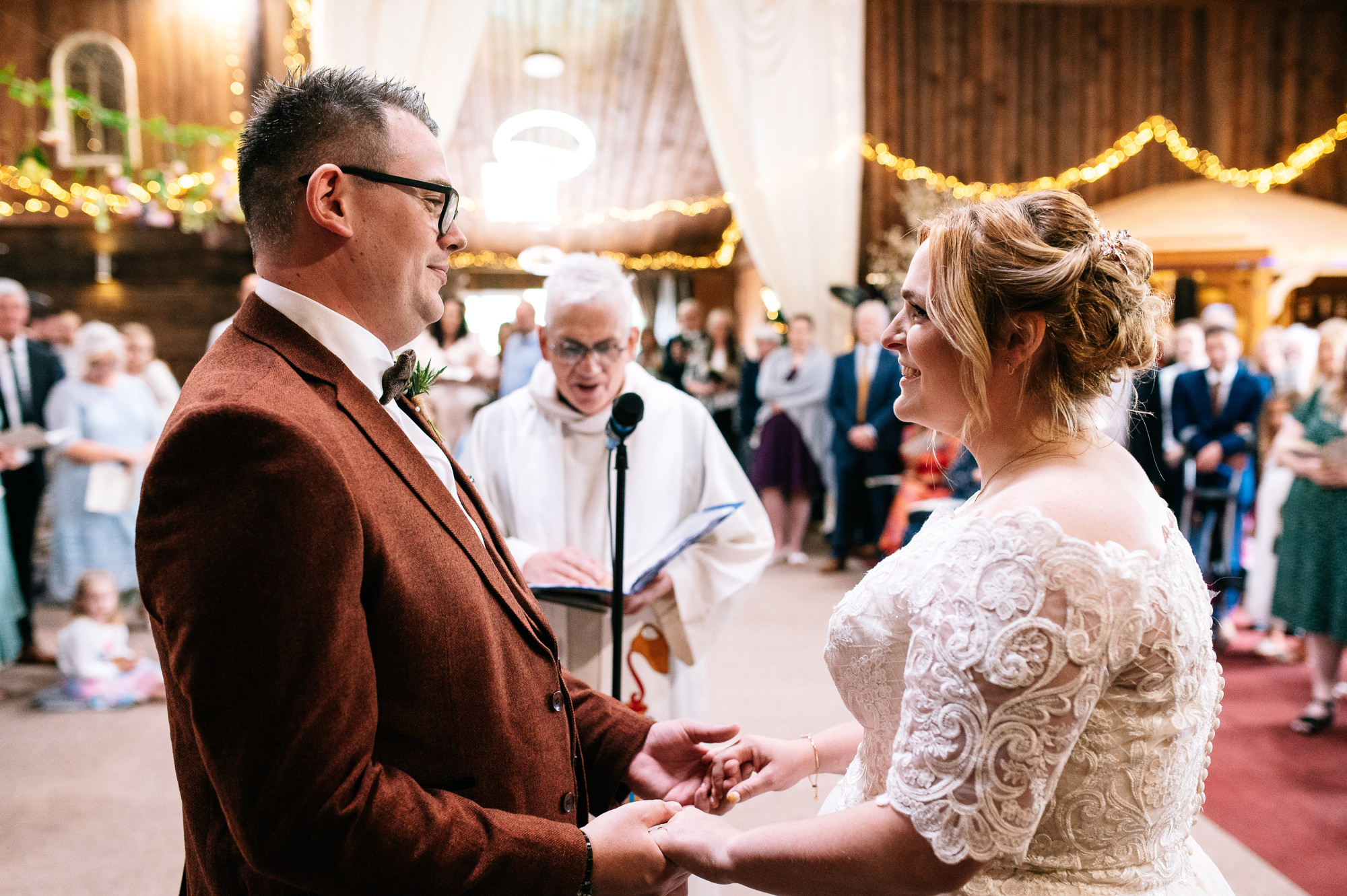 bride and groom holding hands during wedding ceremony