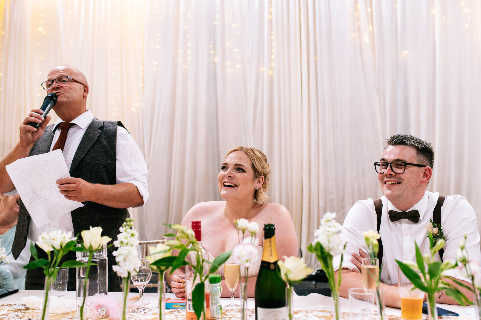 smiling bride during her father's speech
