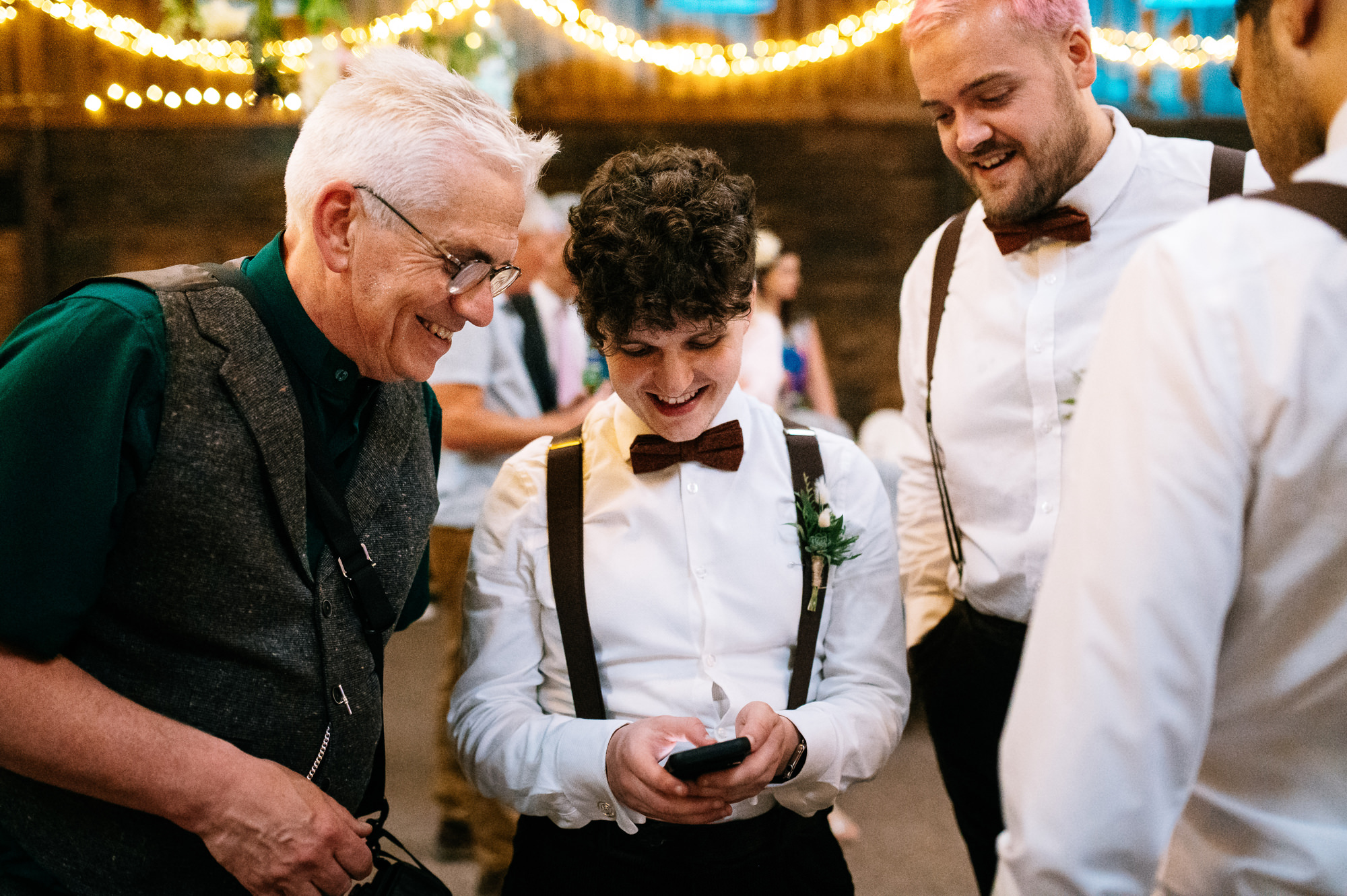 groomsmen looking at something funny on a phone