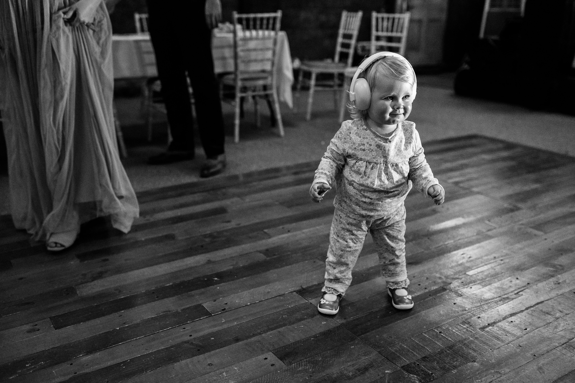 toddler in her pyjamas and ear defenders on the dance floor