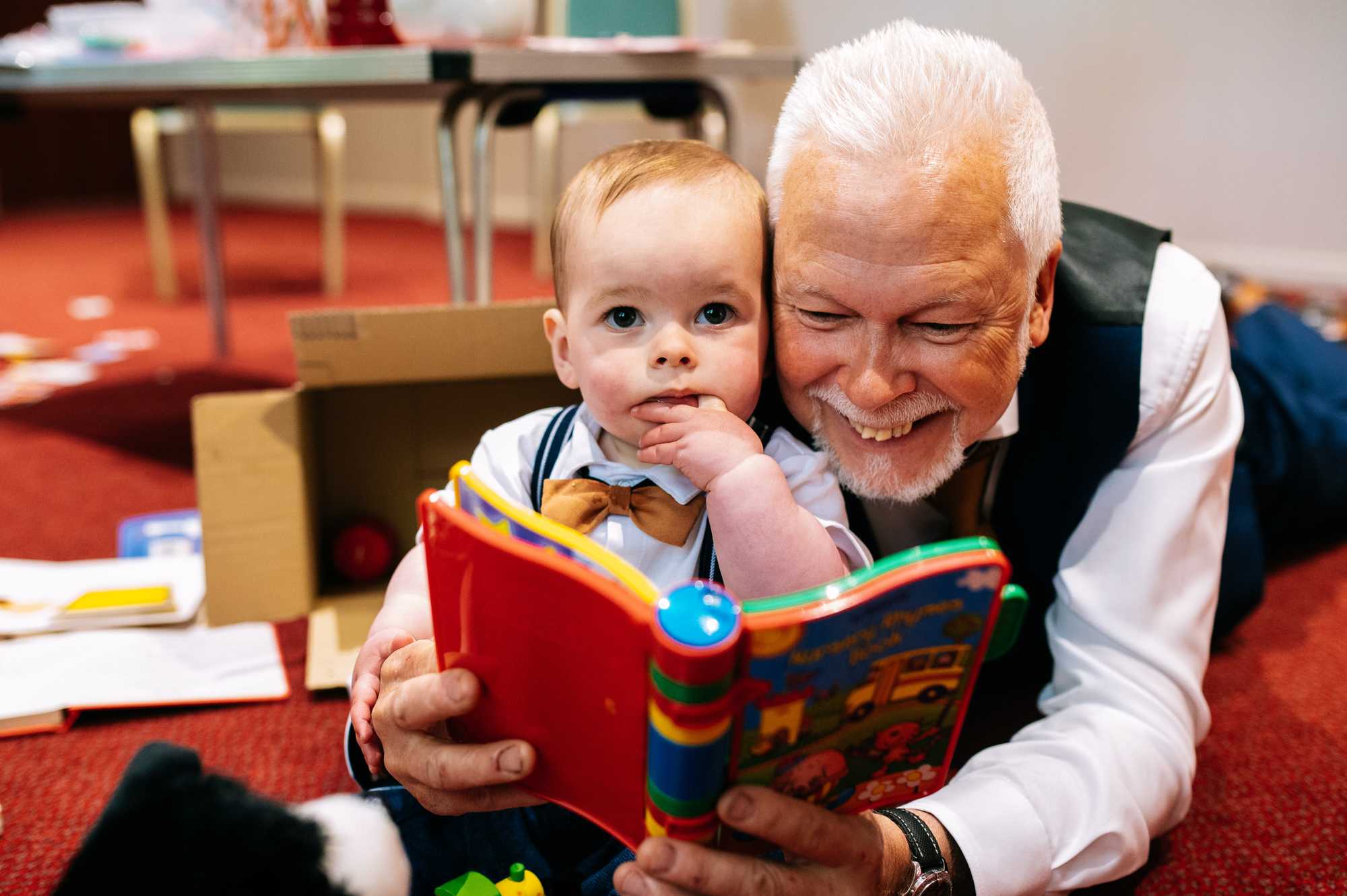 grandad enjoying story time with his grandson