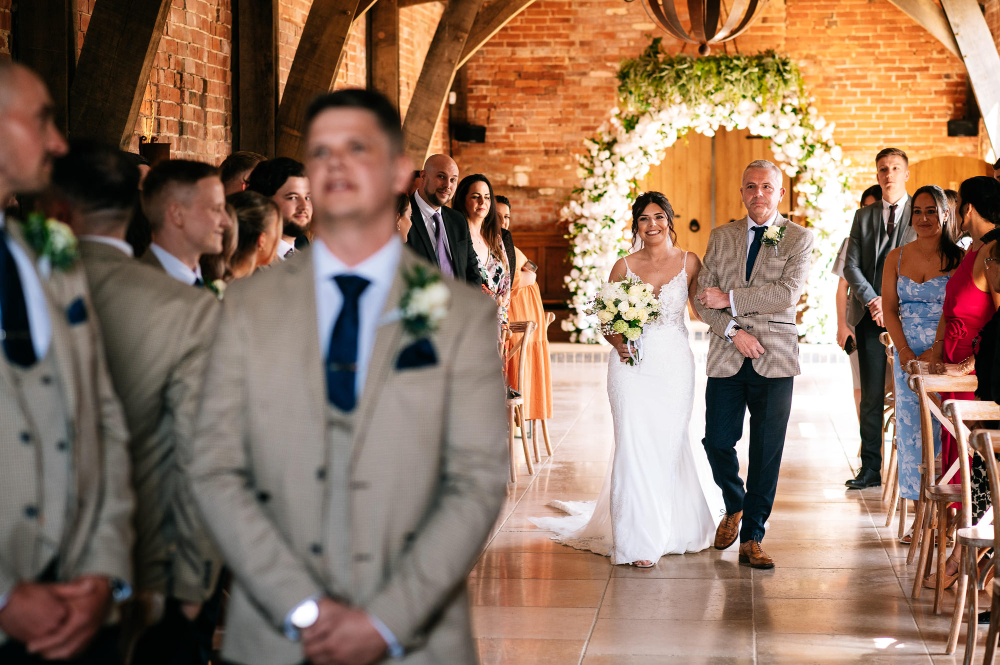 bride walking down the aisle with her dad at grangefields
