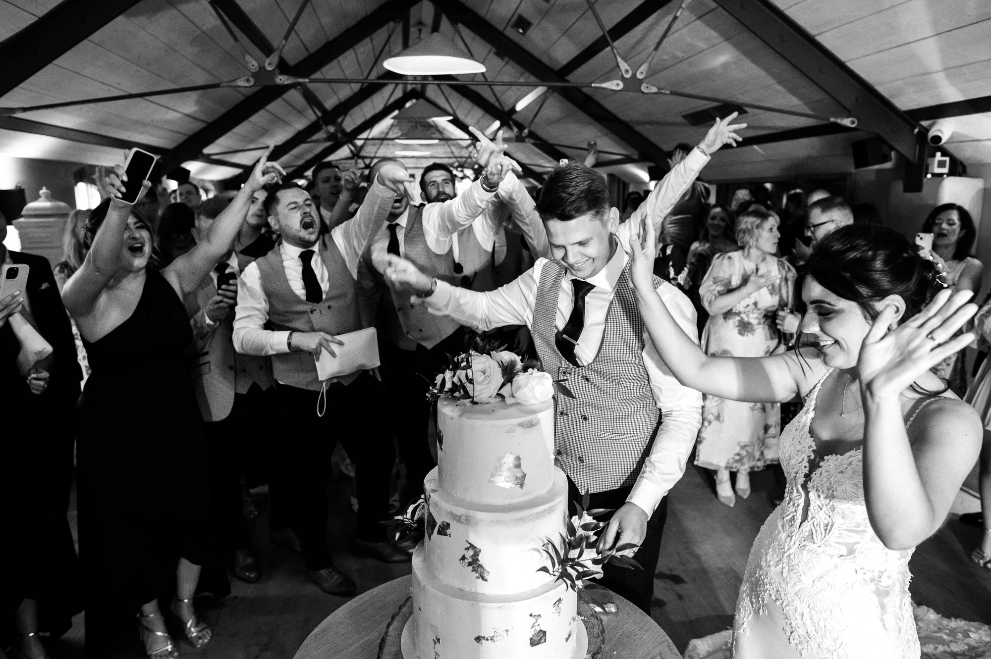 newlyweds and guests celebrate the cake cutting