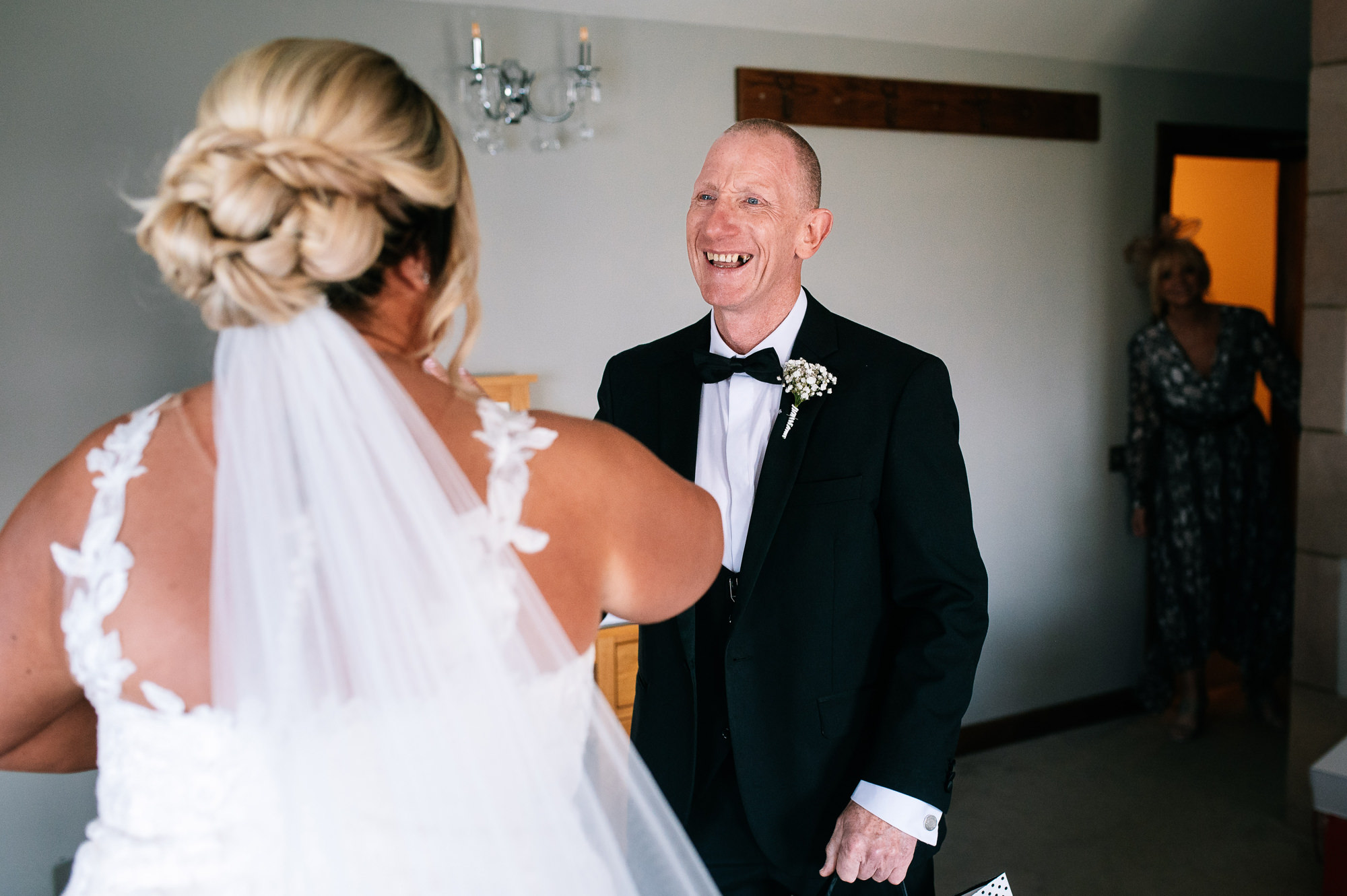 father of the bride sees his daughter in her dress first look