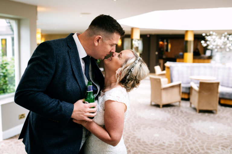bride and groom share a moment before entering their wedding breakfast