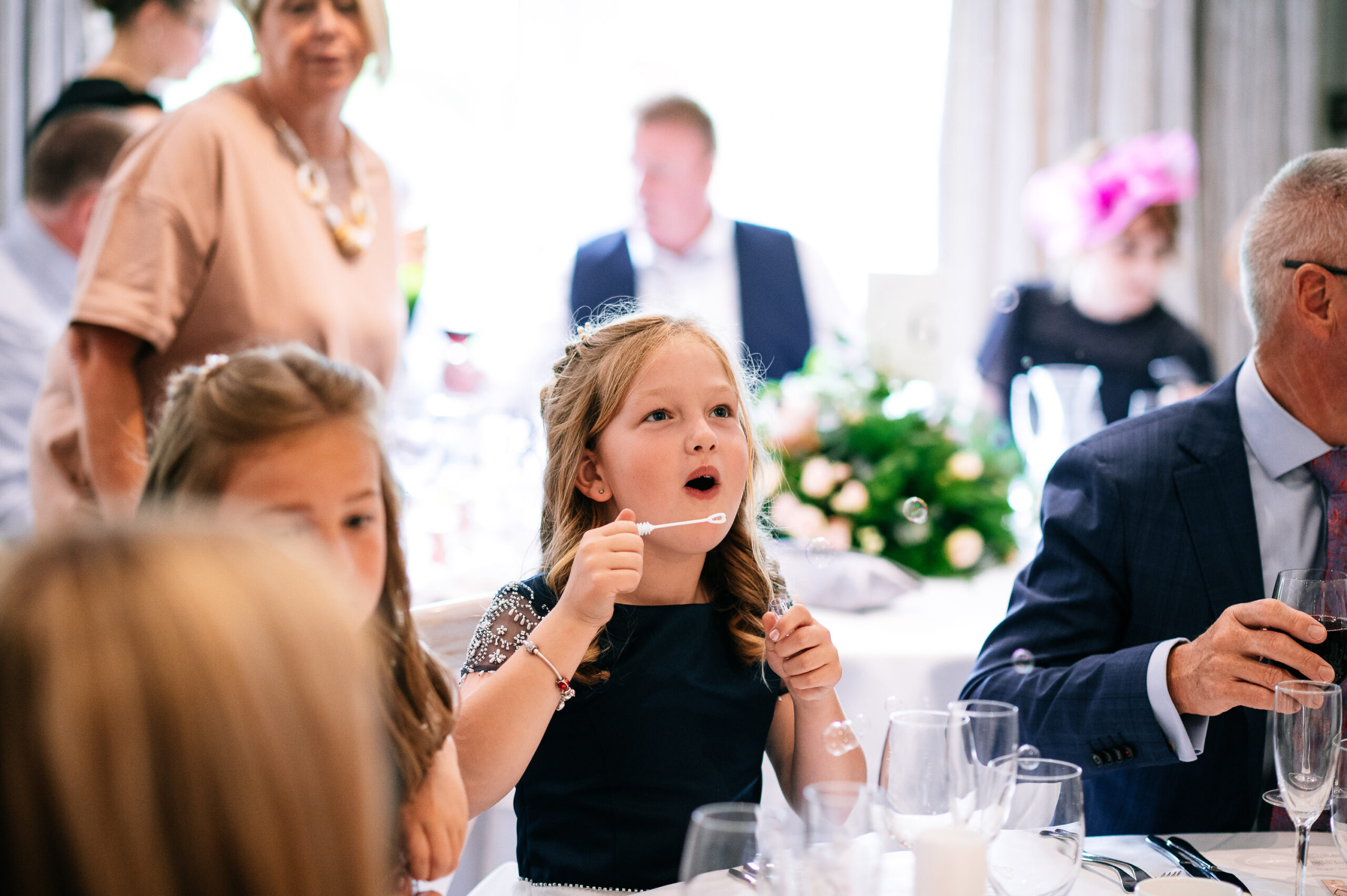 kids blowing bubbles at table