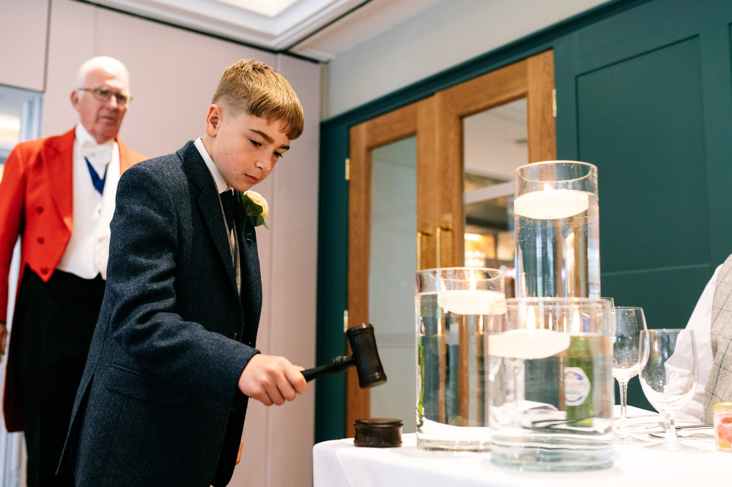 young lad banging a hammer to start the speeches