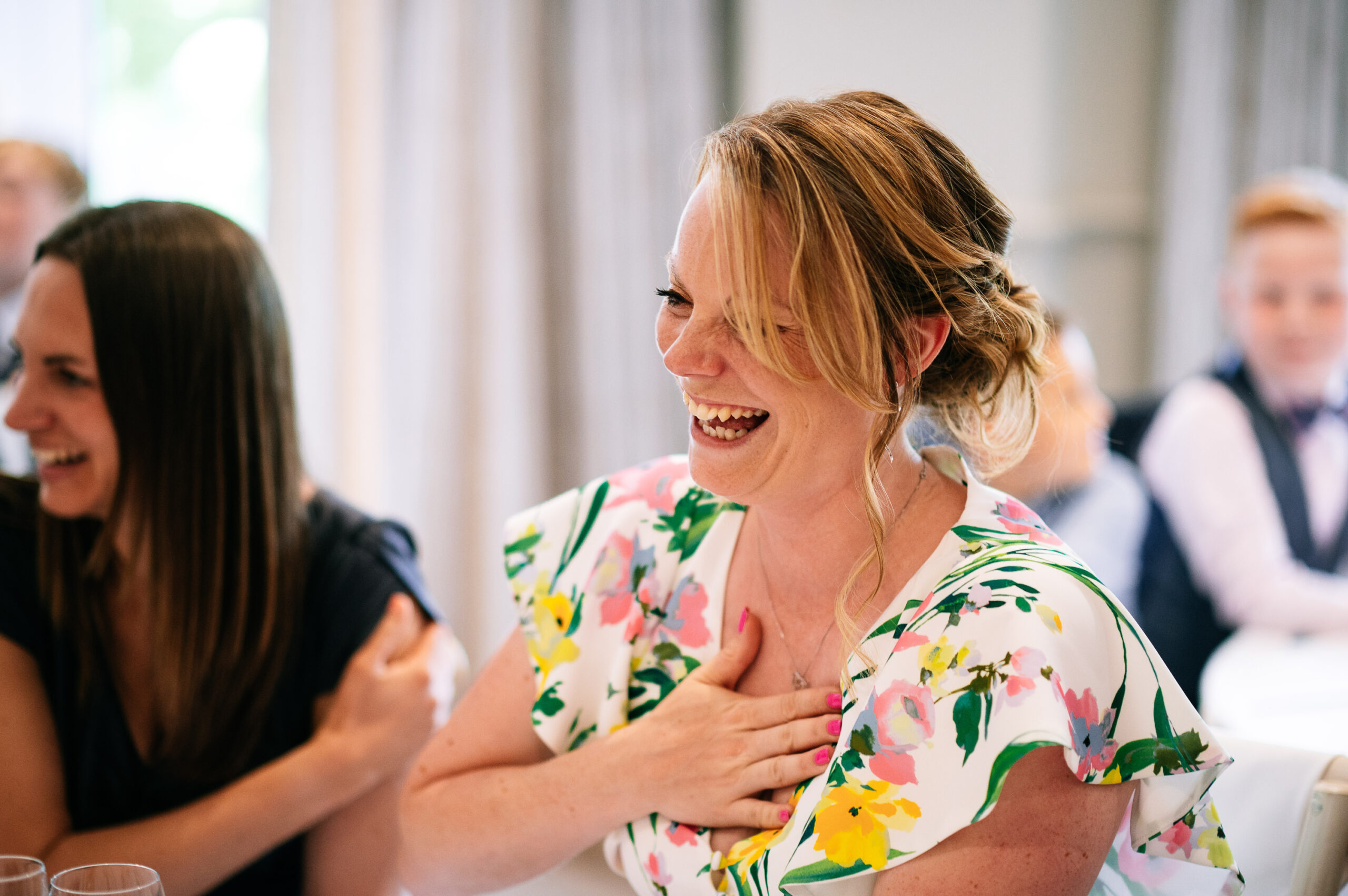 laughing wedding guest during the speeches