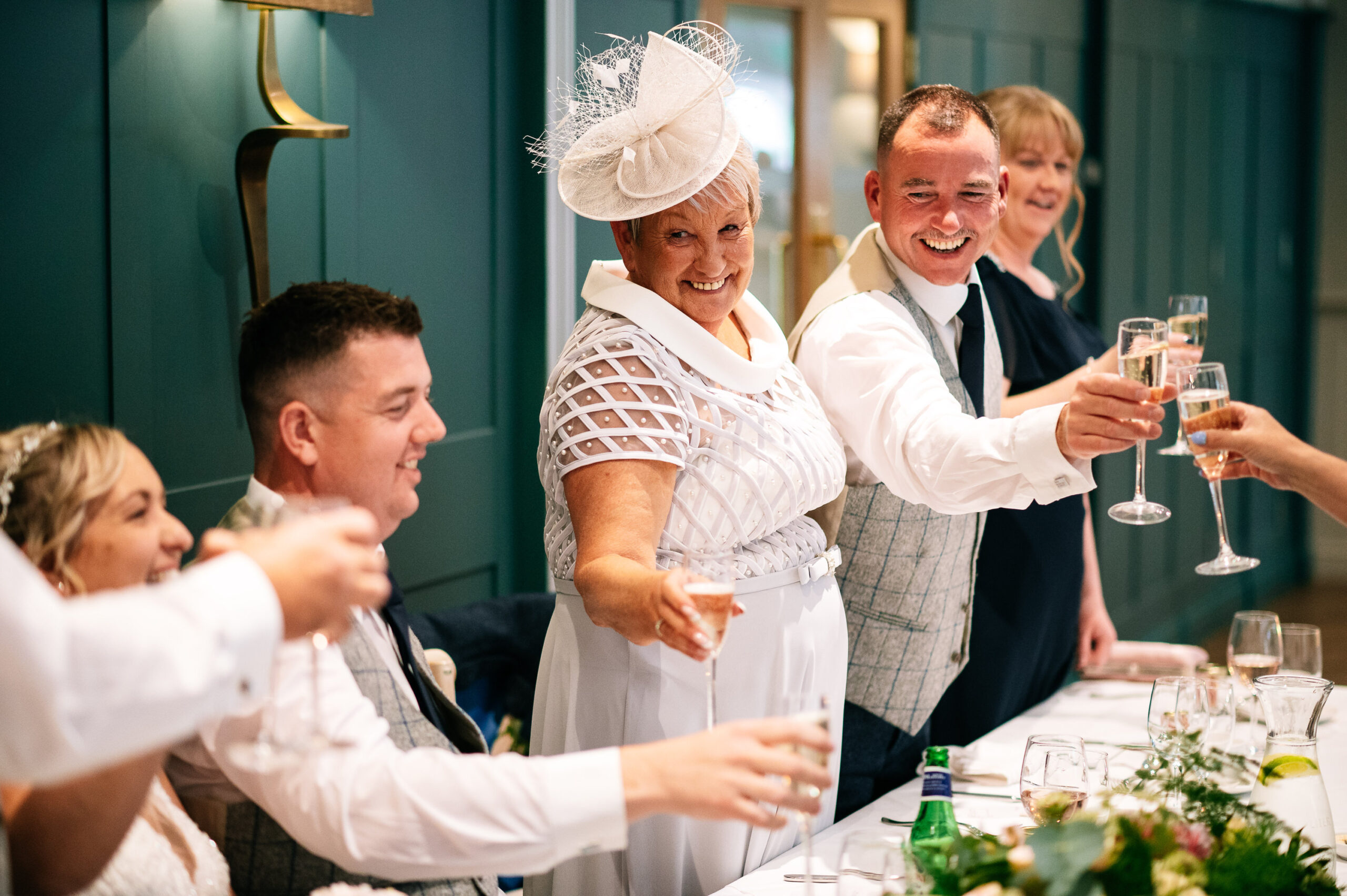 family on the top table raise their glasses