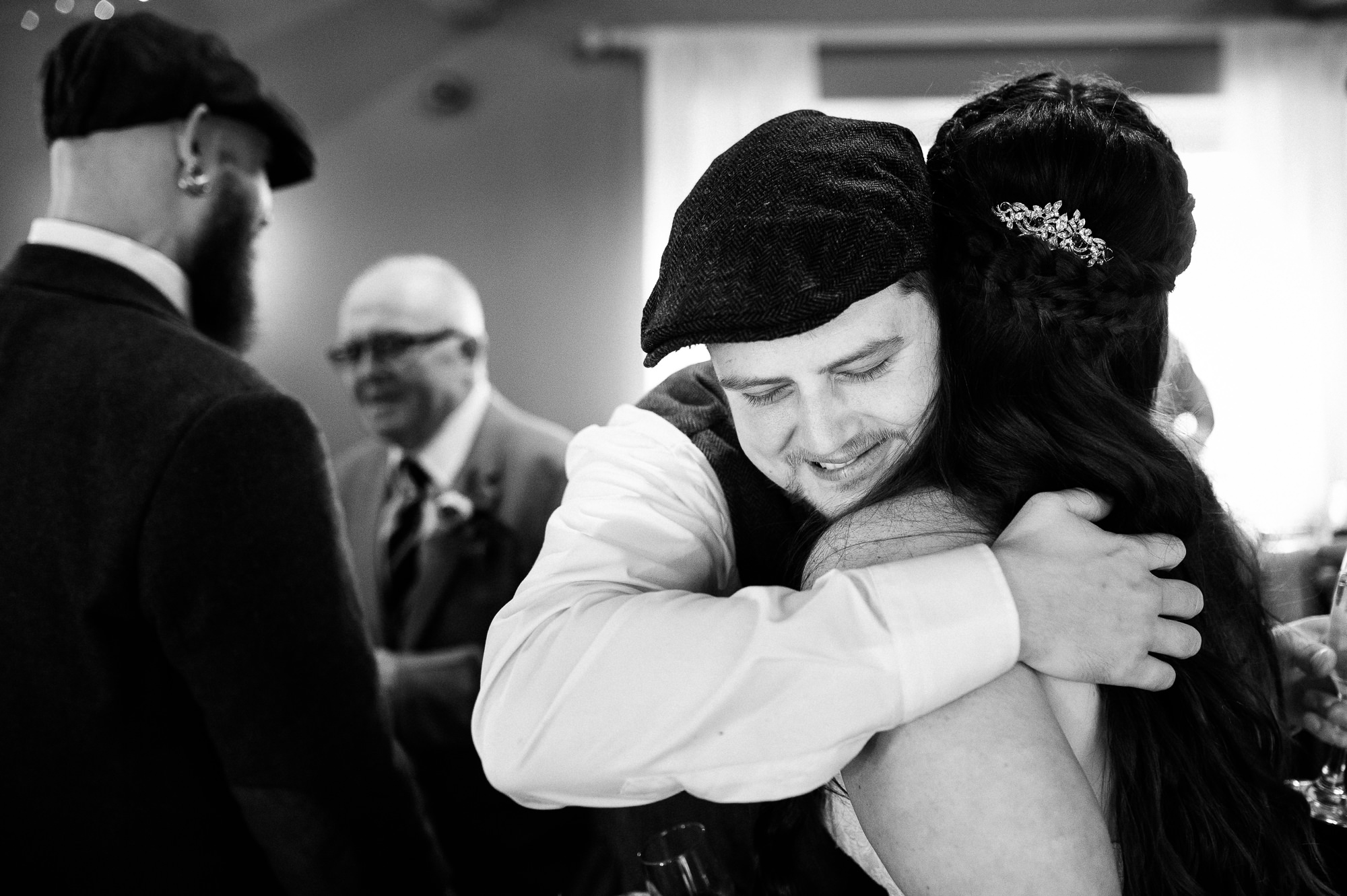 groomsman giving an emotional hug