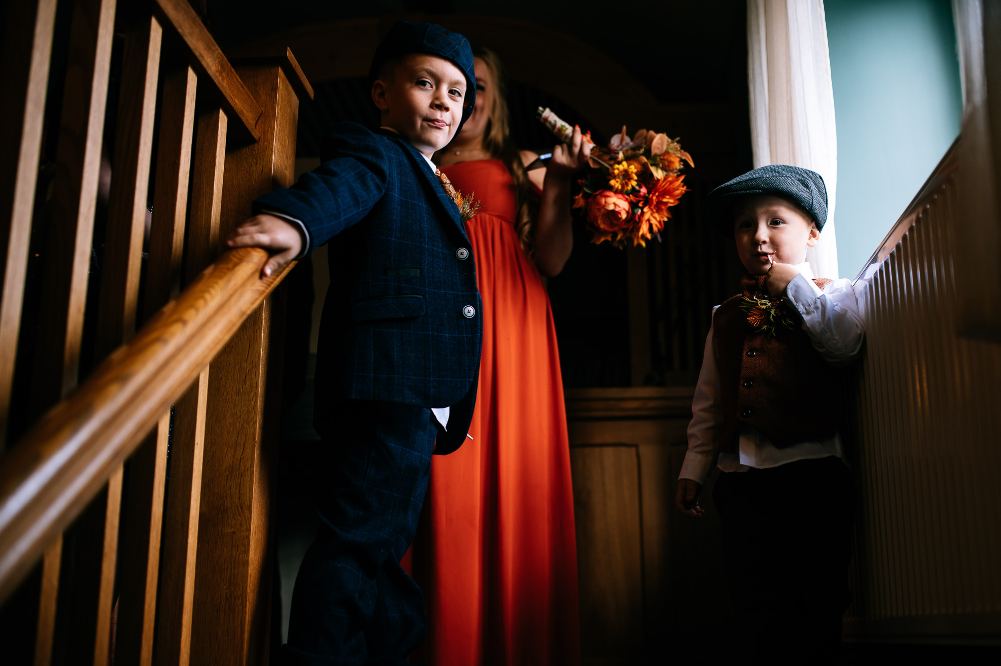 kids at a wedding loitering at the top of the stairs