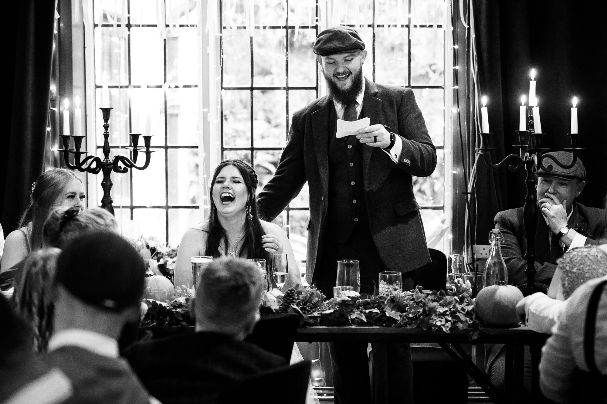 bride laughing during the groom's speech