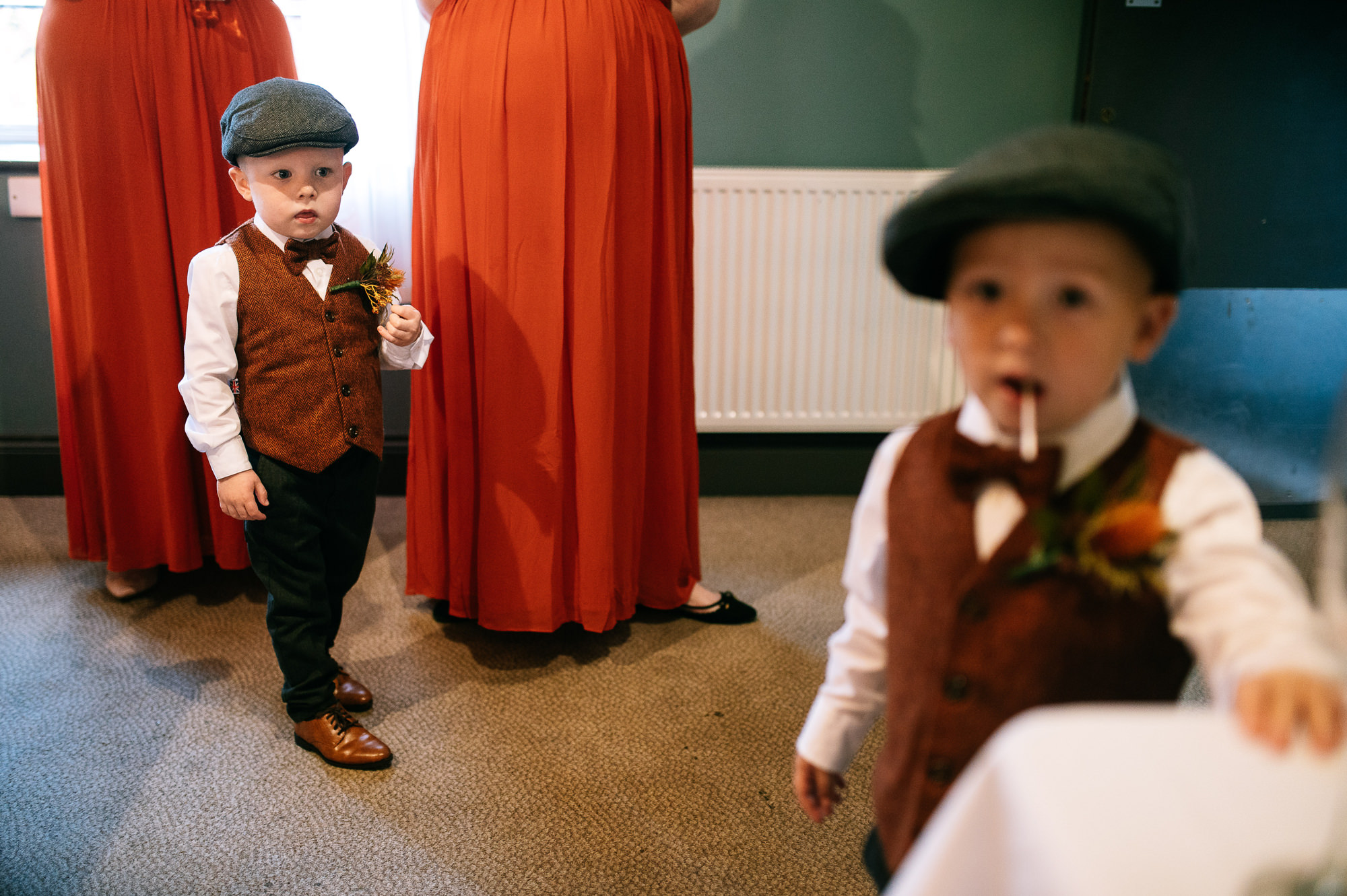 two small boys wearing waistcoats and flat caps