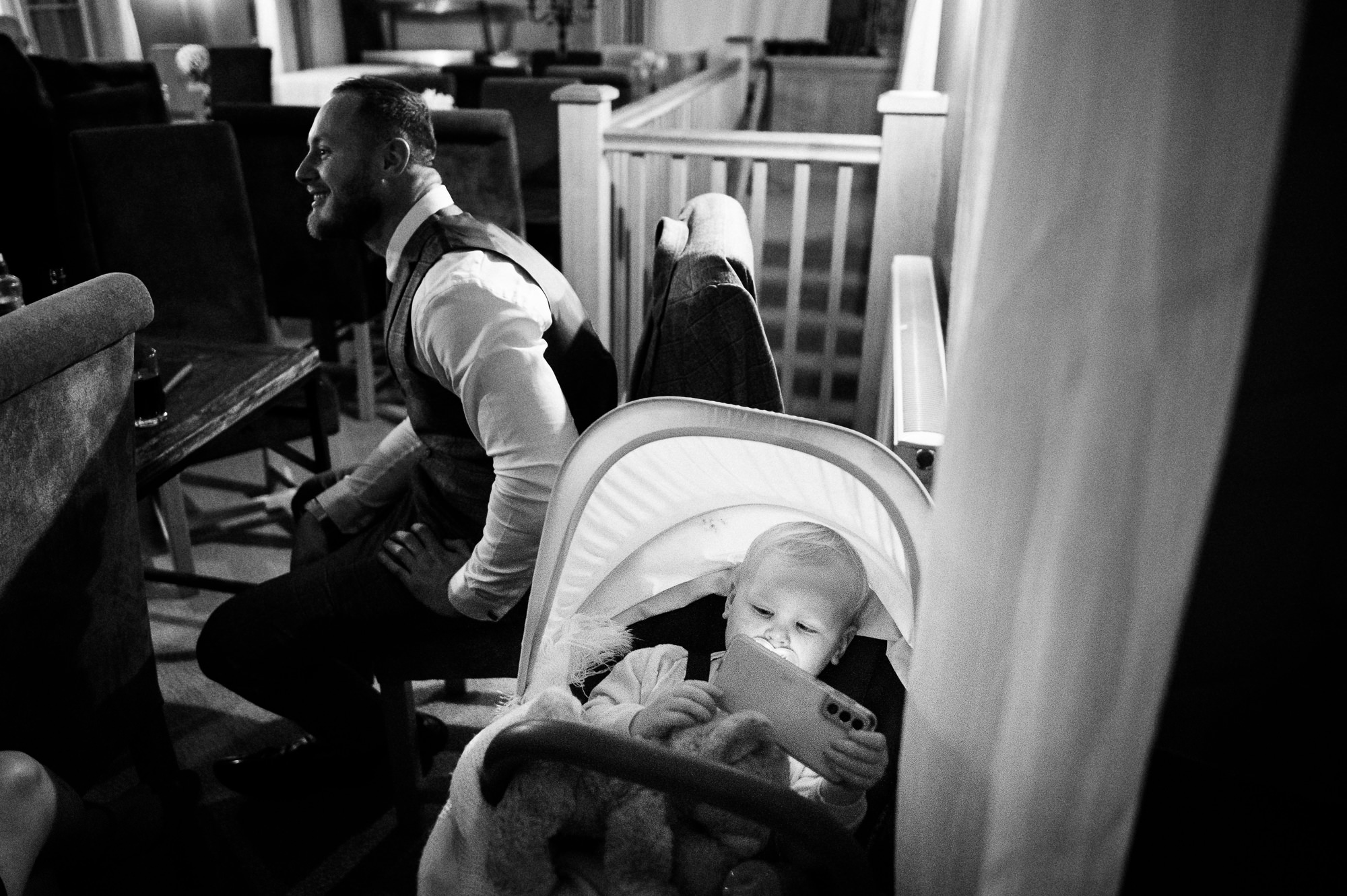 kid in a pram with their face illuminated by a smart phone