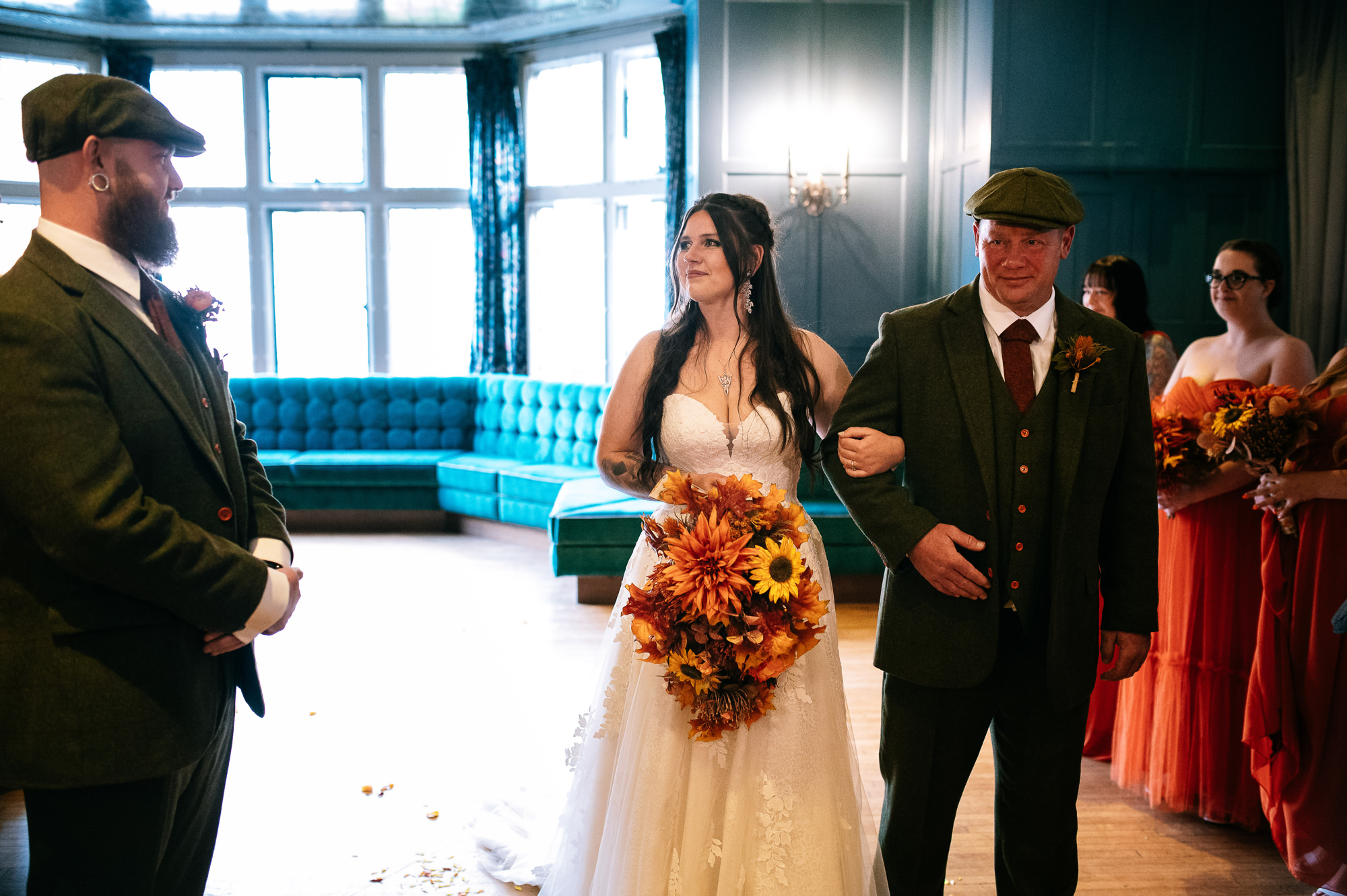 bride being walked down the aisle by her father