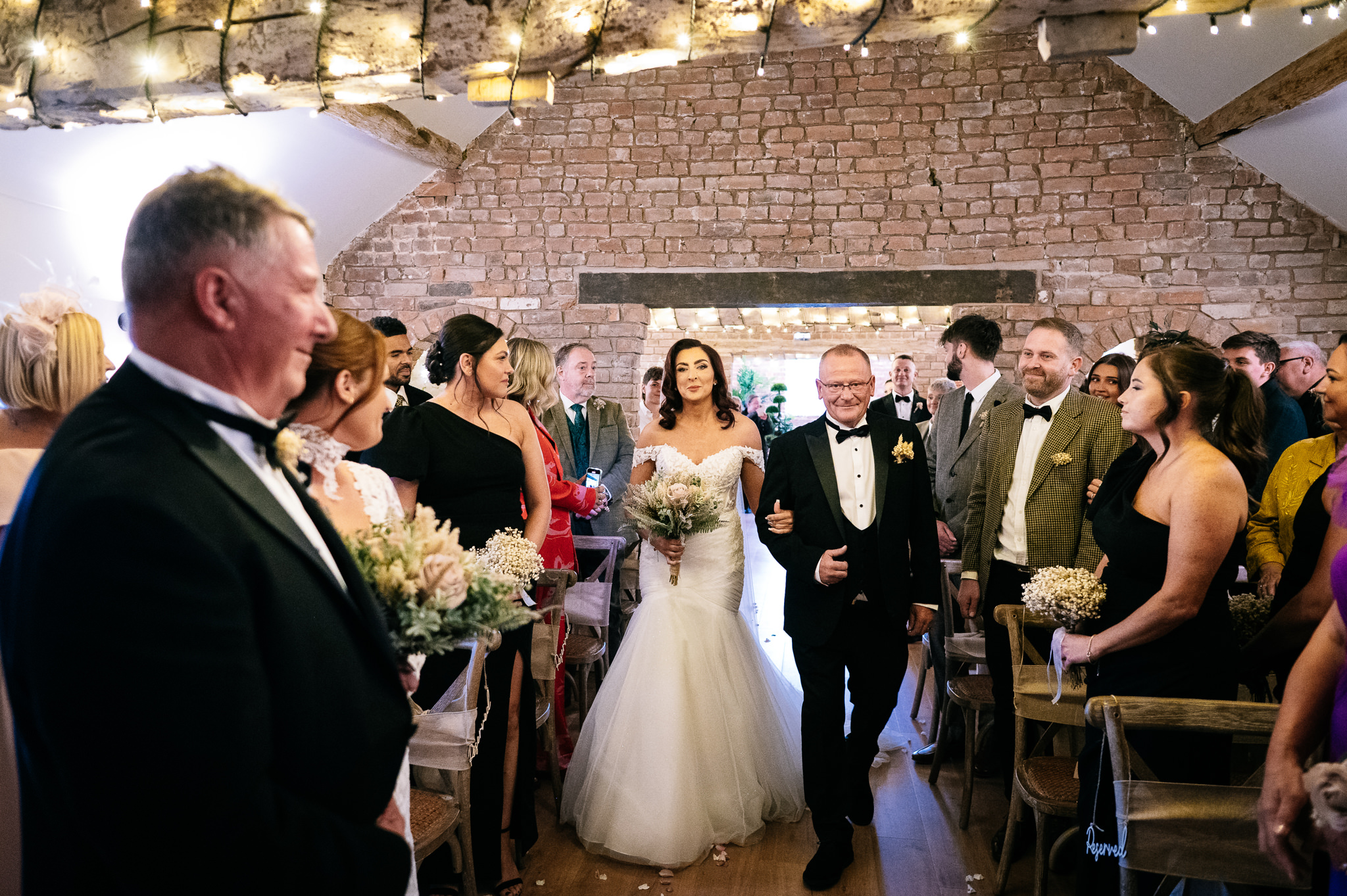 bride walking down the aisle with her dad