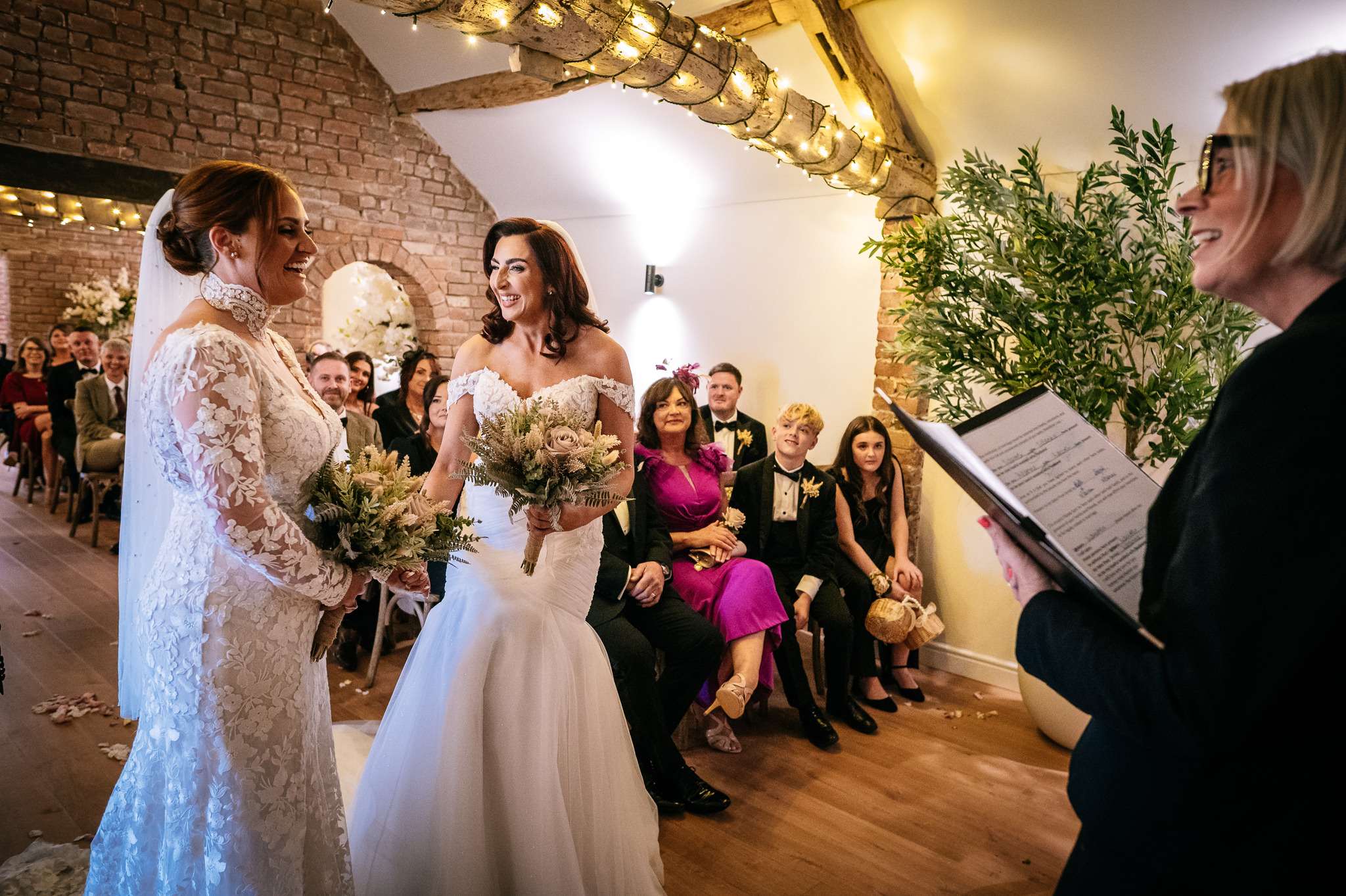 brides laughing during a barn wedding ceremony