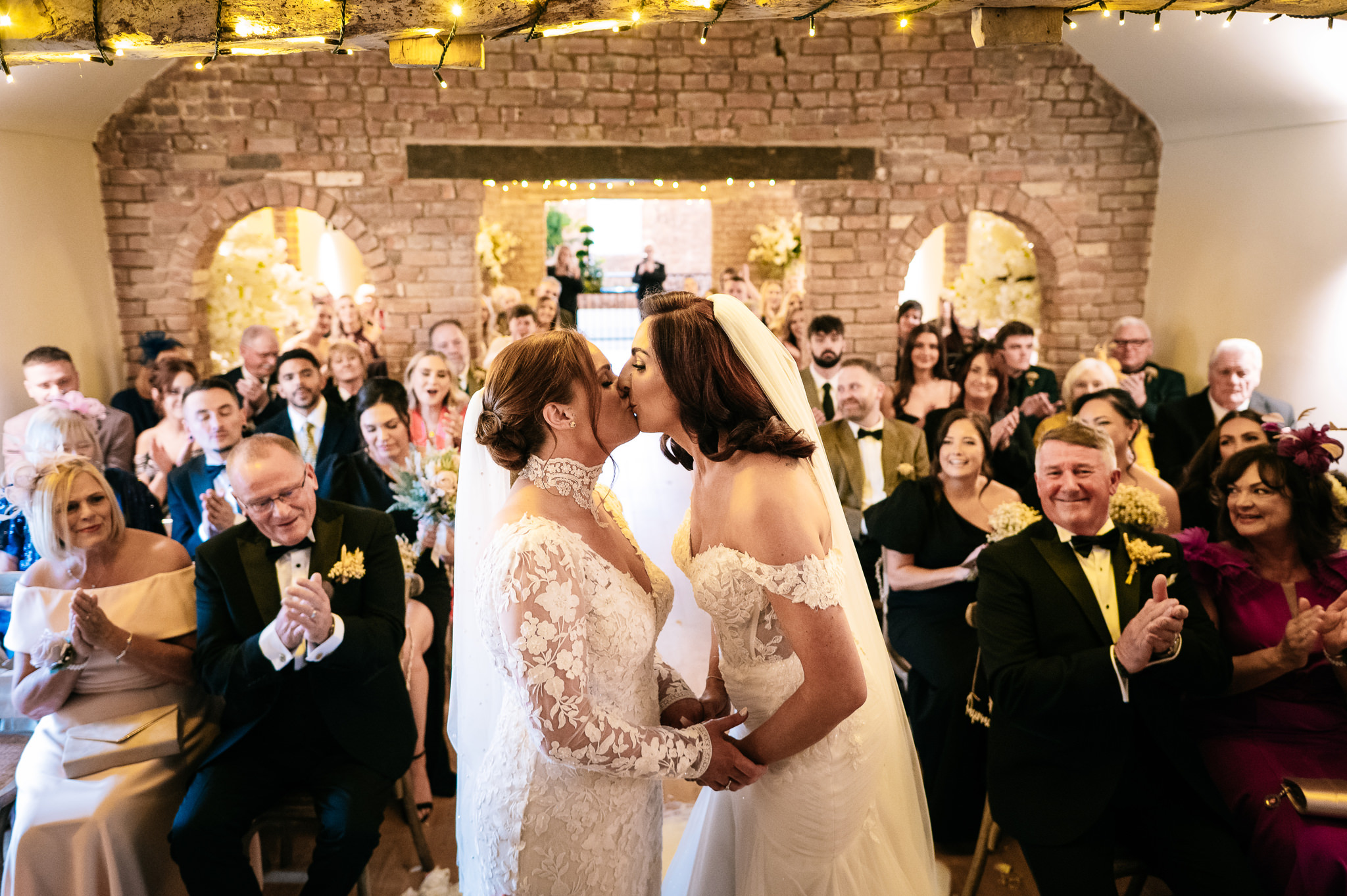 two brides just married at the cheshire venue share a first kiss