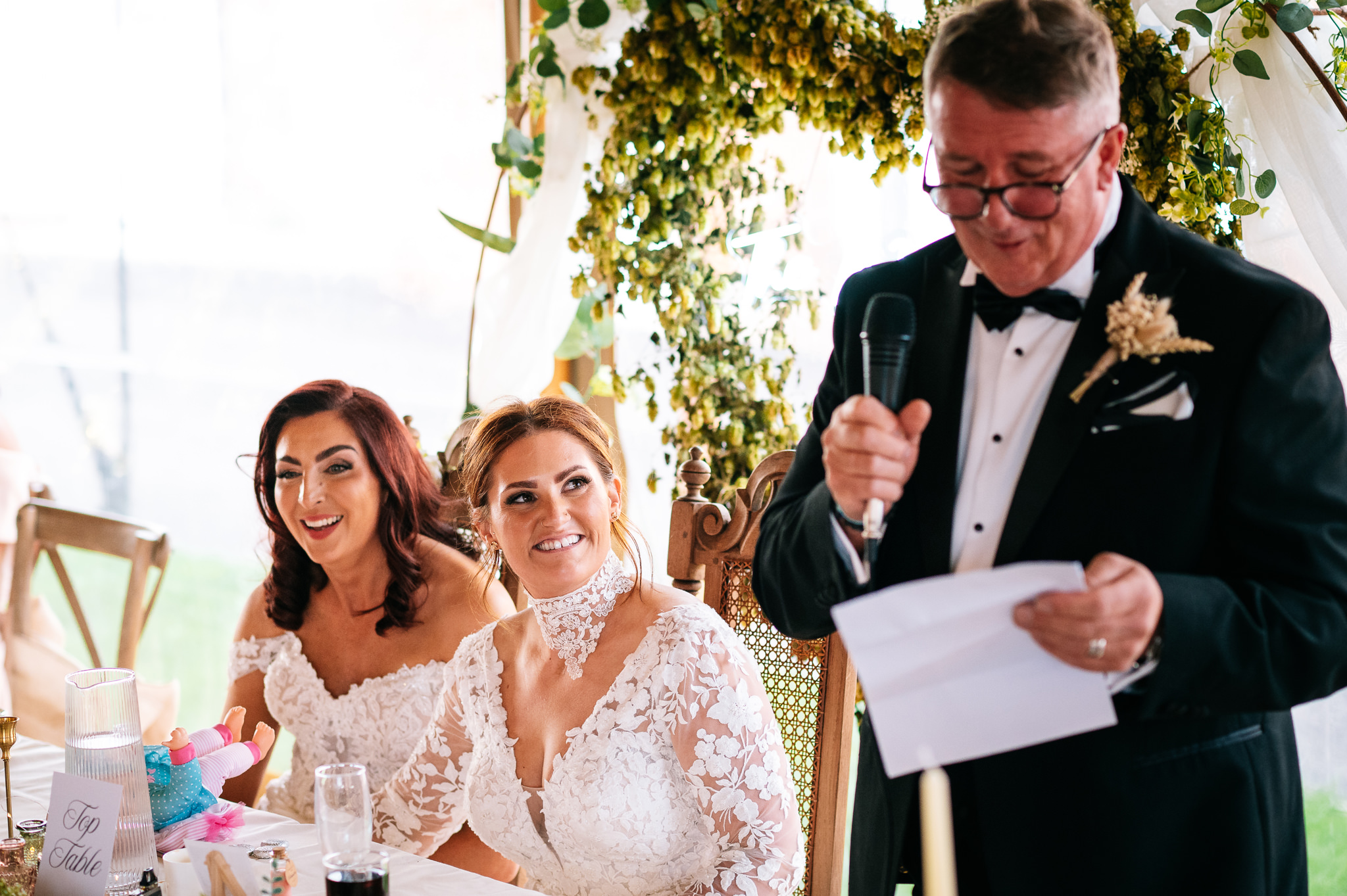 laughing brides during the father of the bride's speech