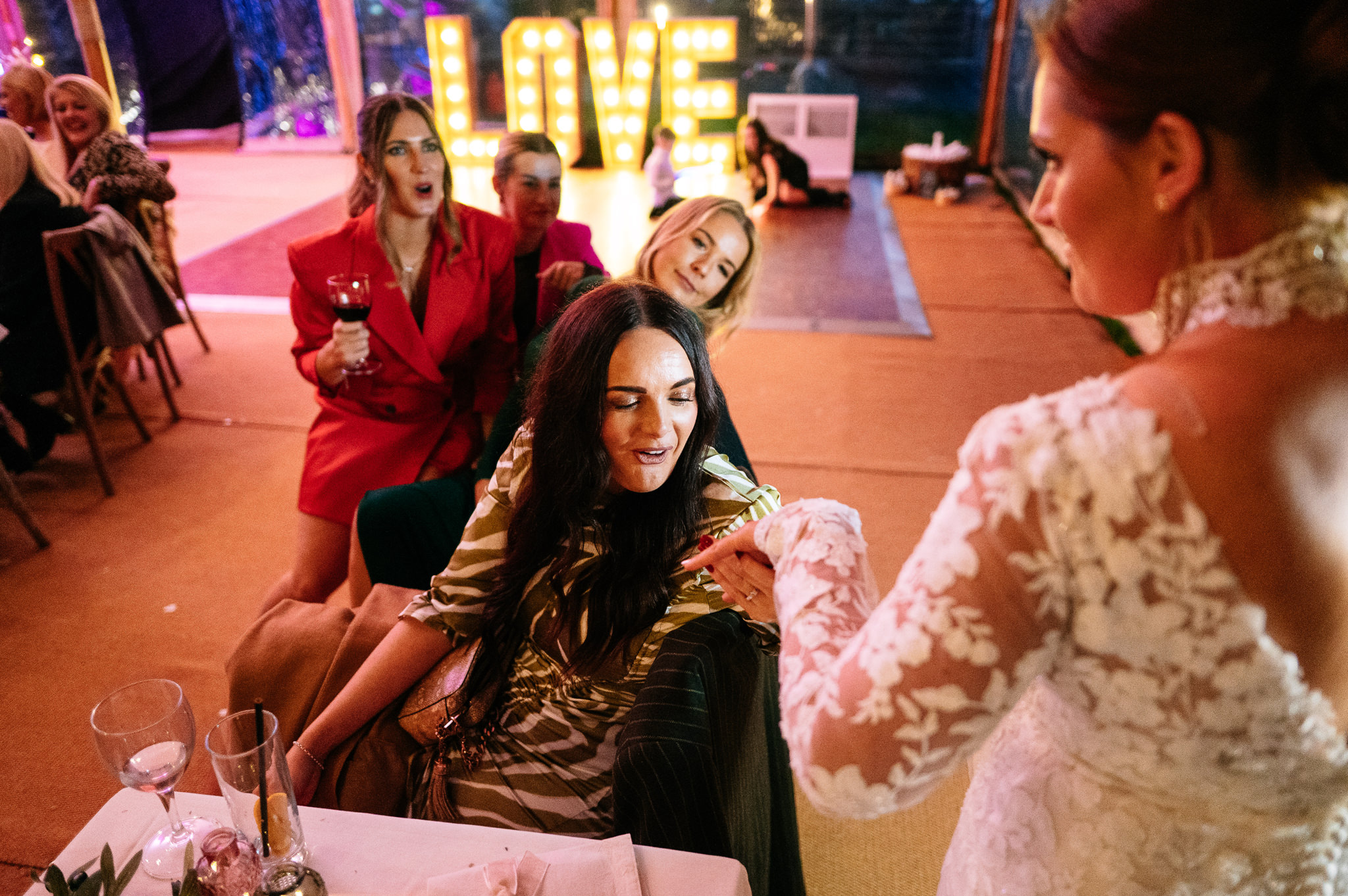 friends of the bride admiring her wedding ring