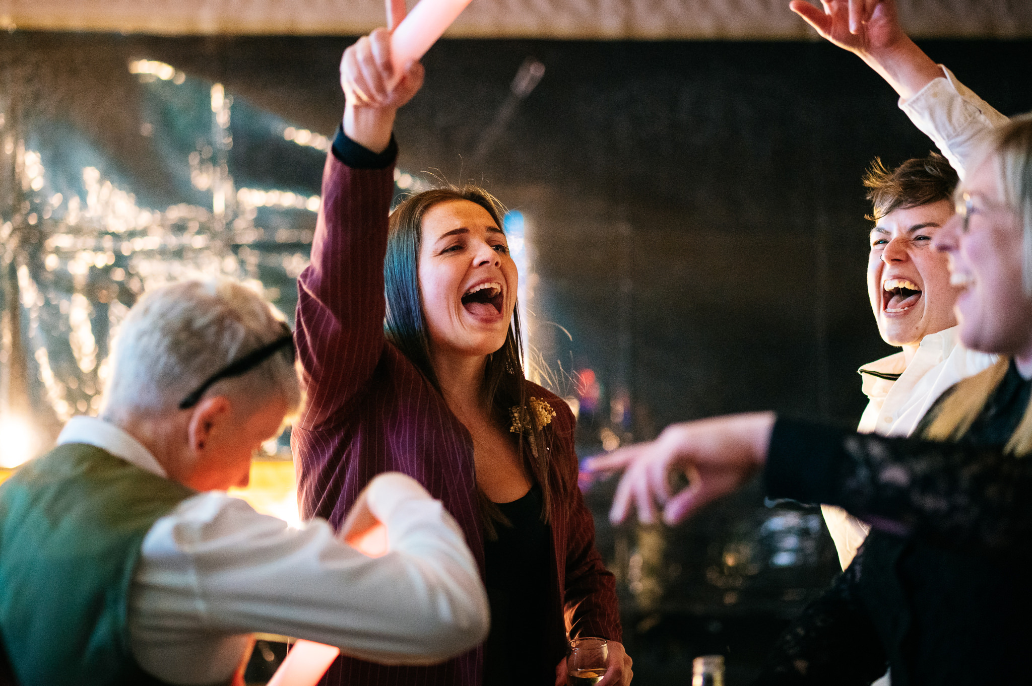two women singing along together at a wedding reception