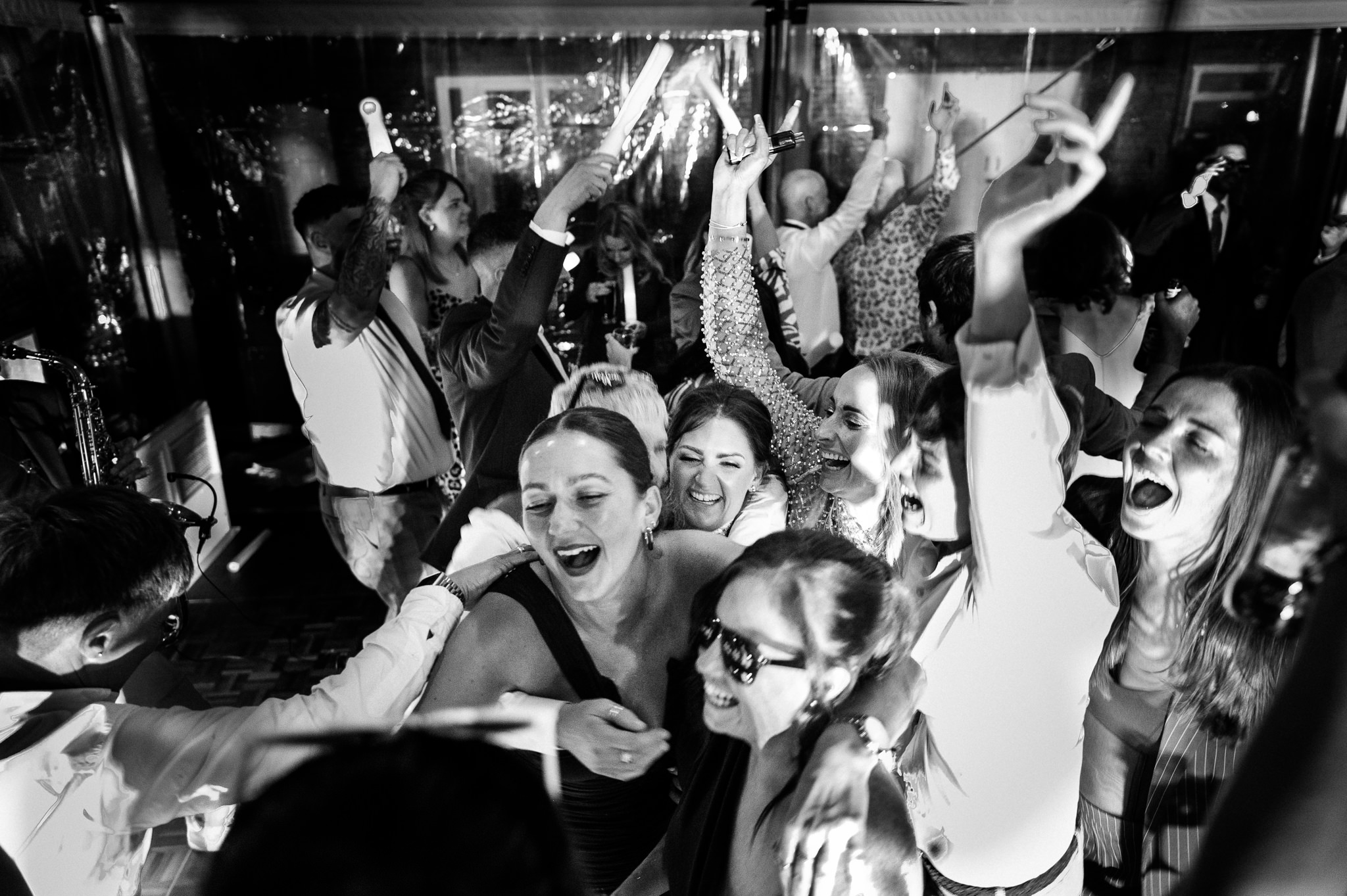 a group of friends shouting and singing on the dancefloor