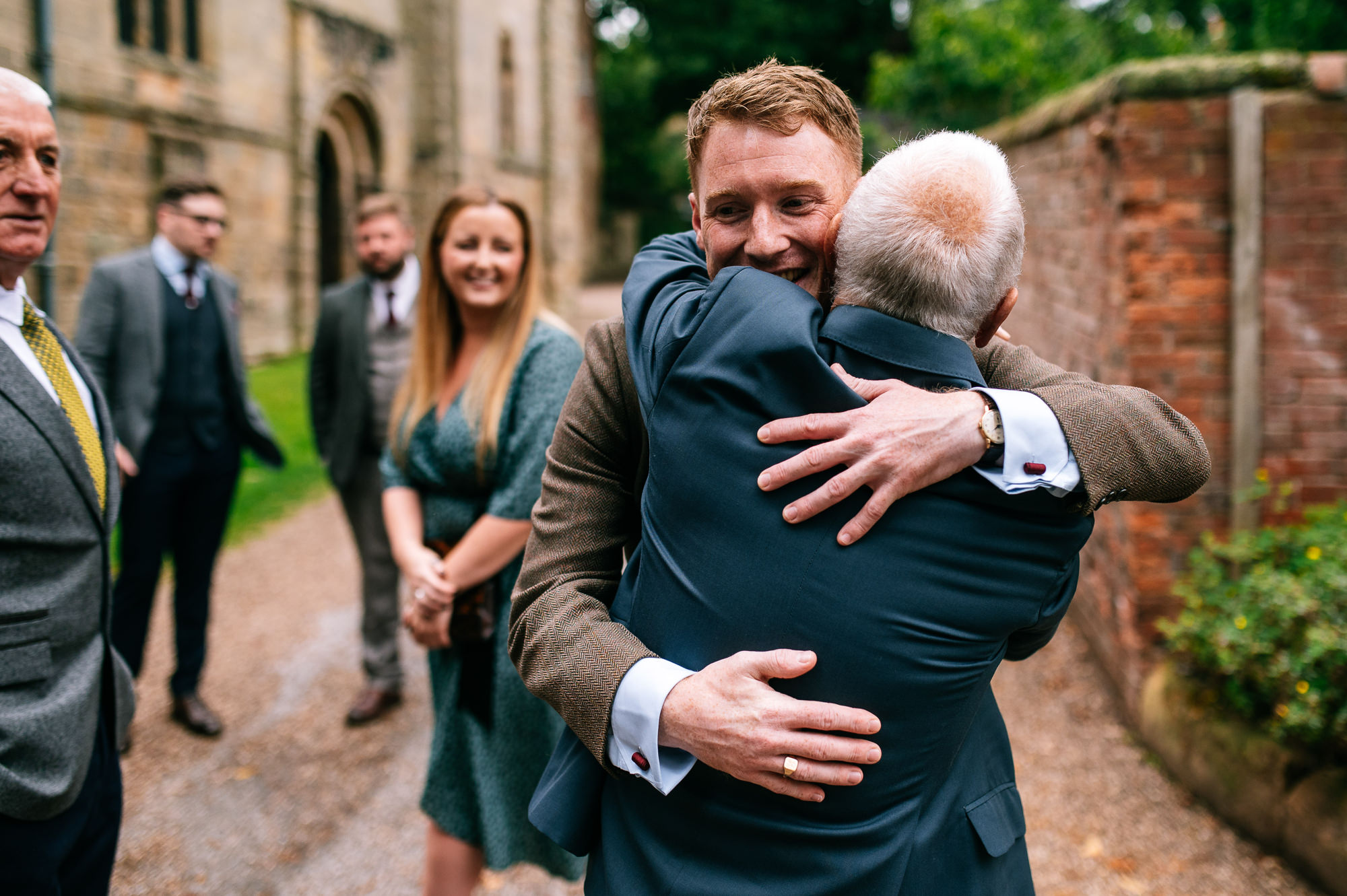 groom greeting wedding guests