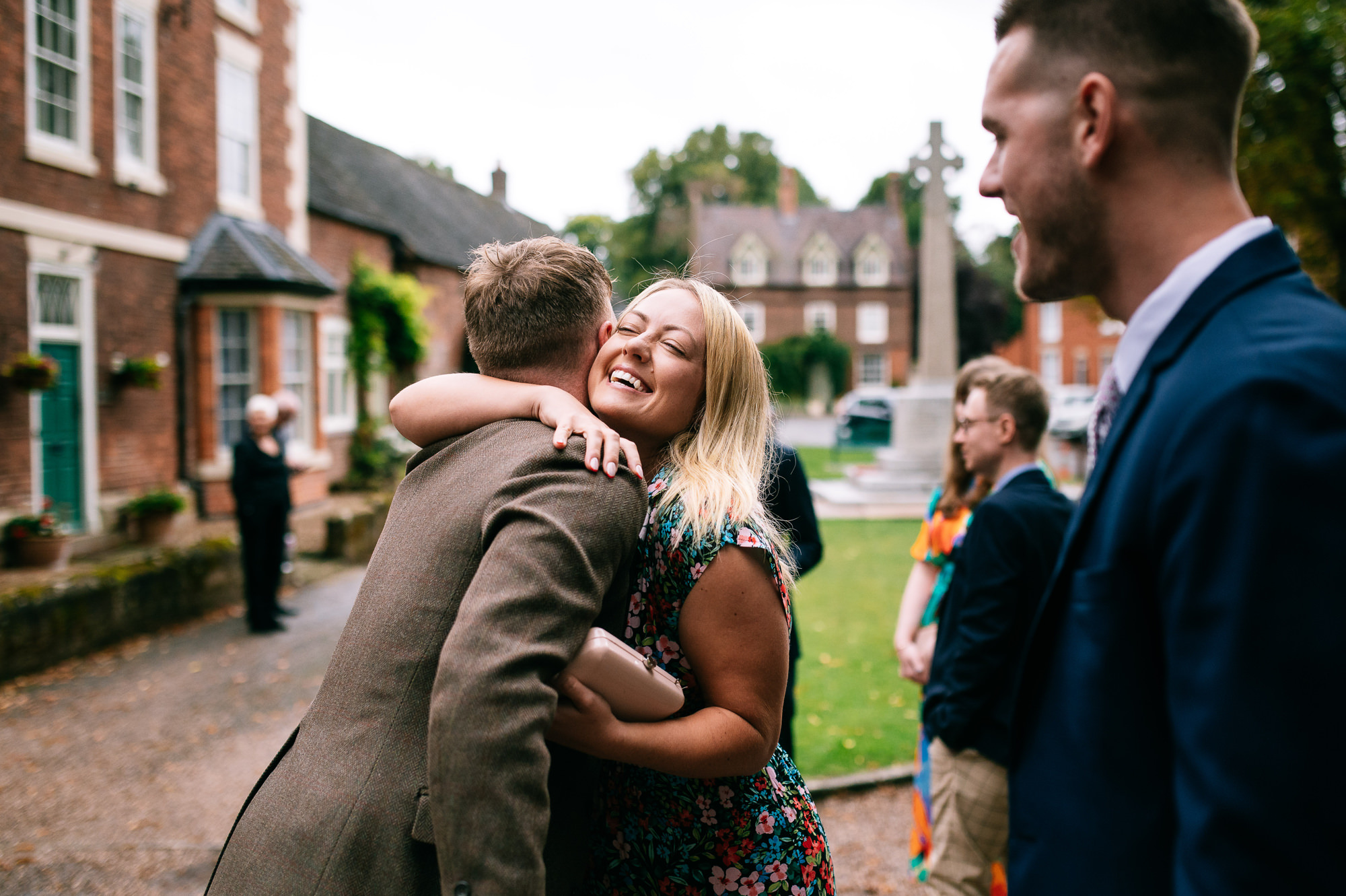 guests hugging outside the church