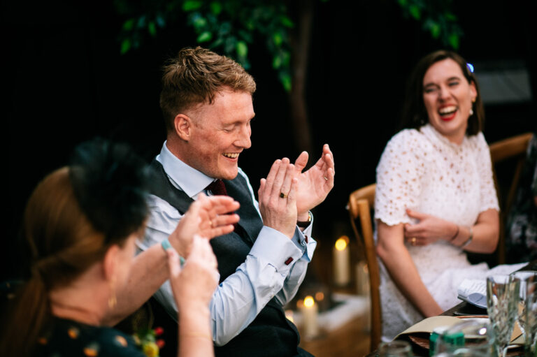 groom clapping during speeches