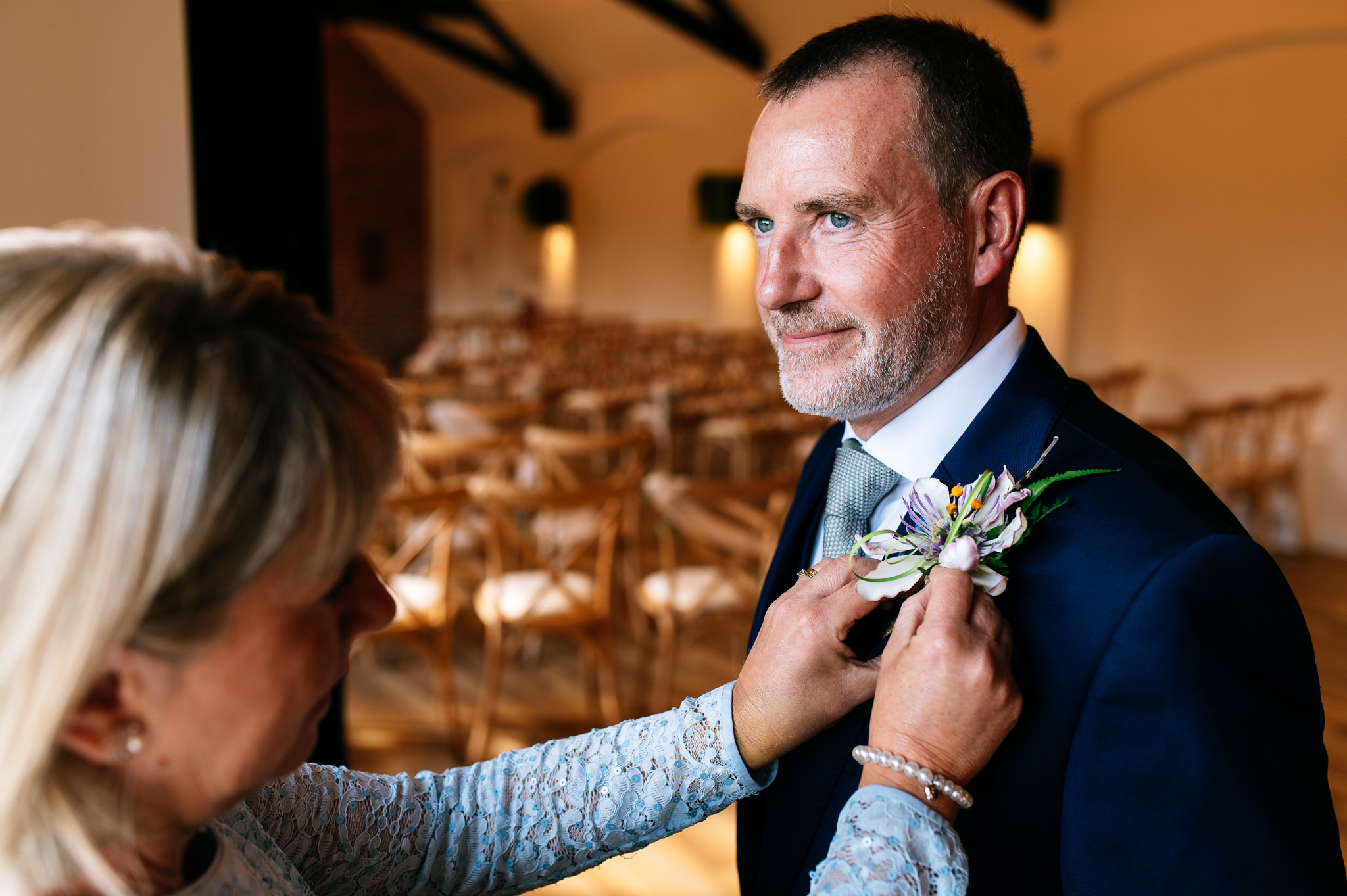 groom having his button hole attached