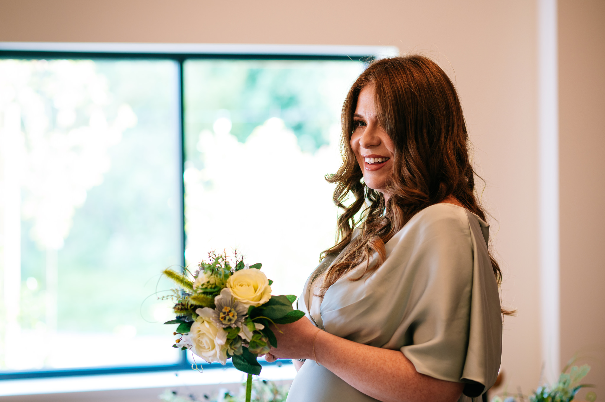 smiling daughter of the bride giving a reading during the ceremony