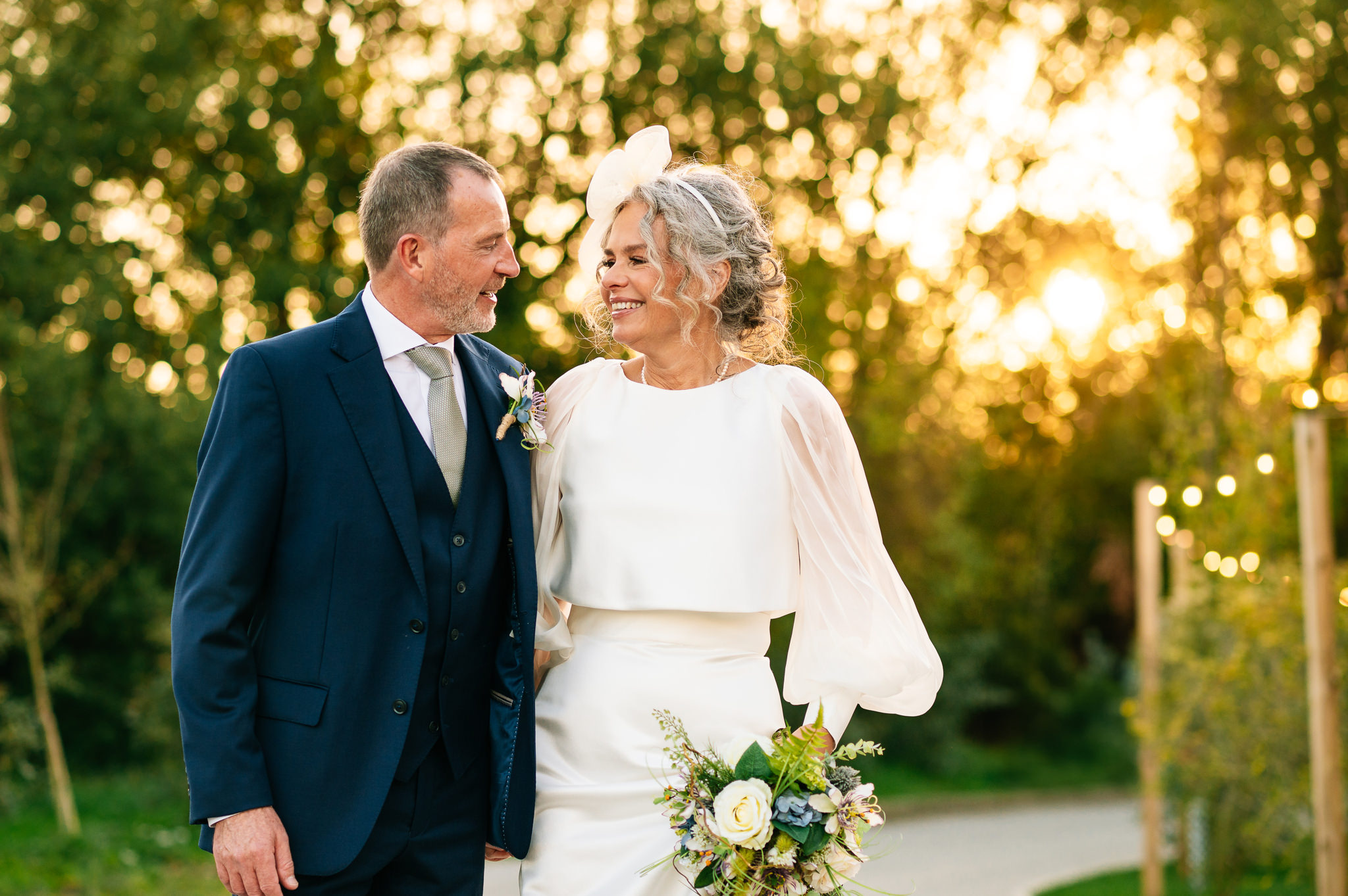 whistle barns wedding photograph of a happy bride and groom with the sunset behind them
