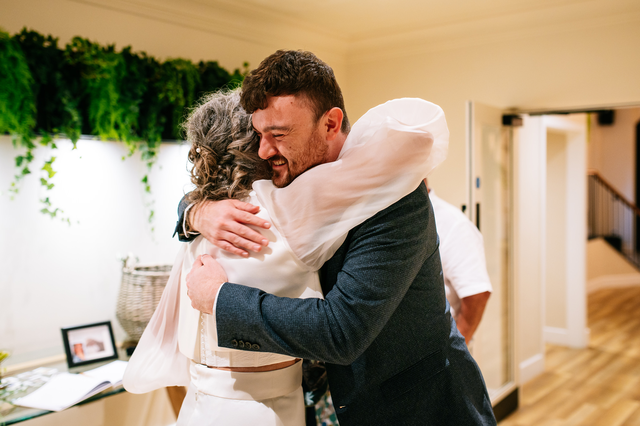 bride greeting her evening guests with a hug