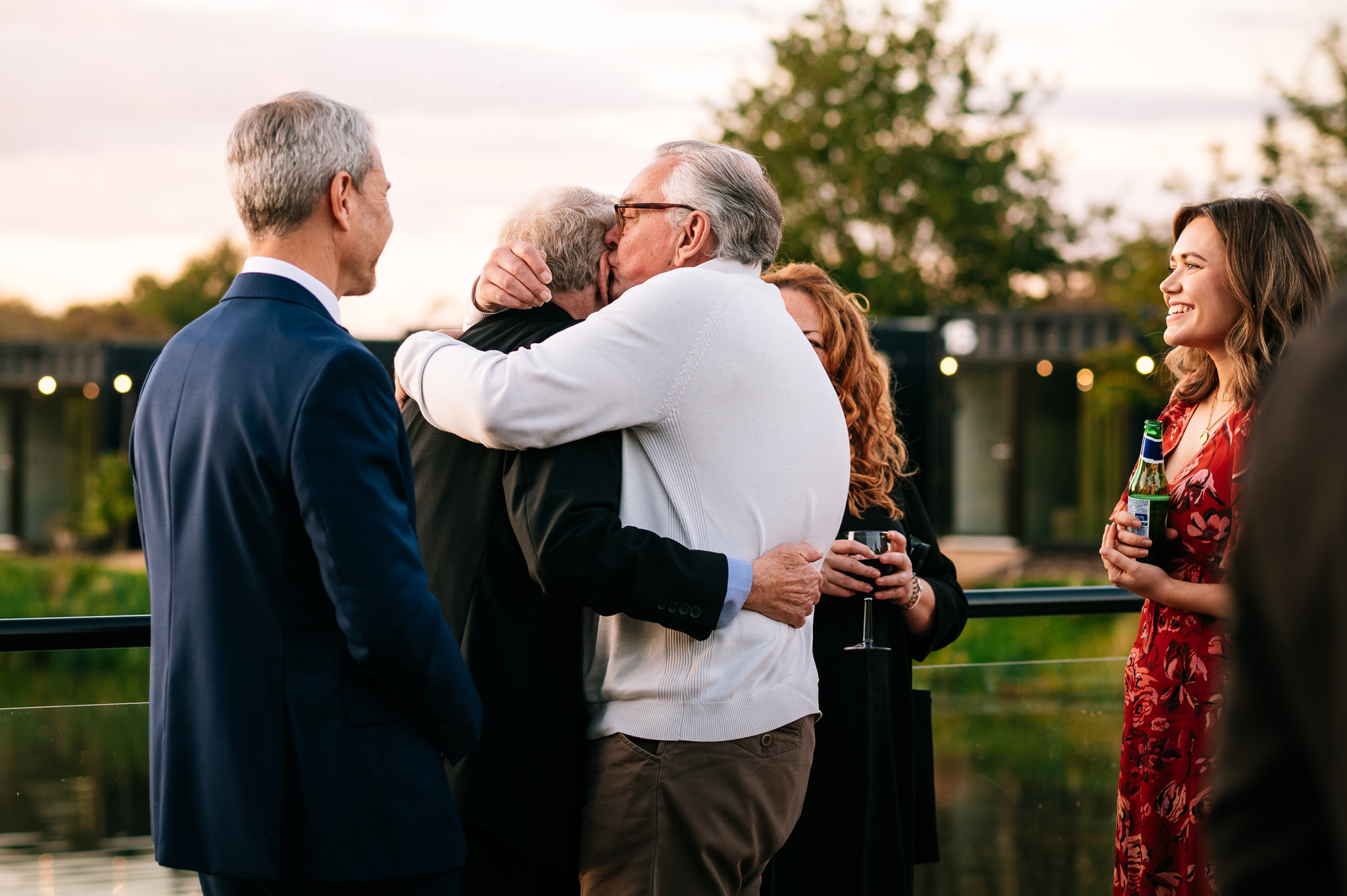 two men hugging each other, with one giving the other a kiss on the head