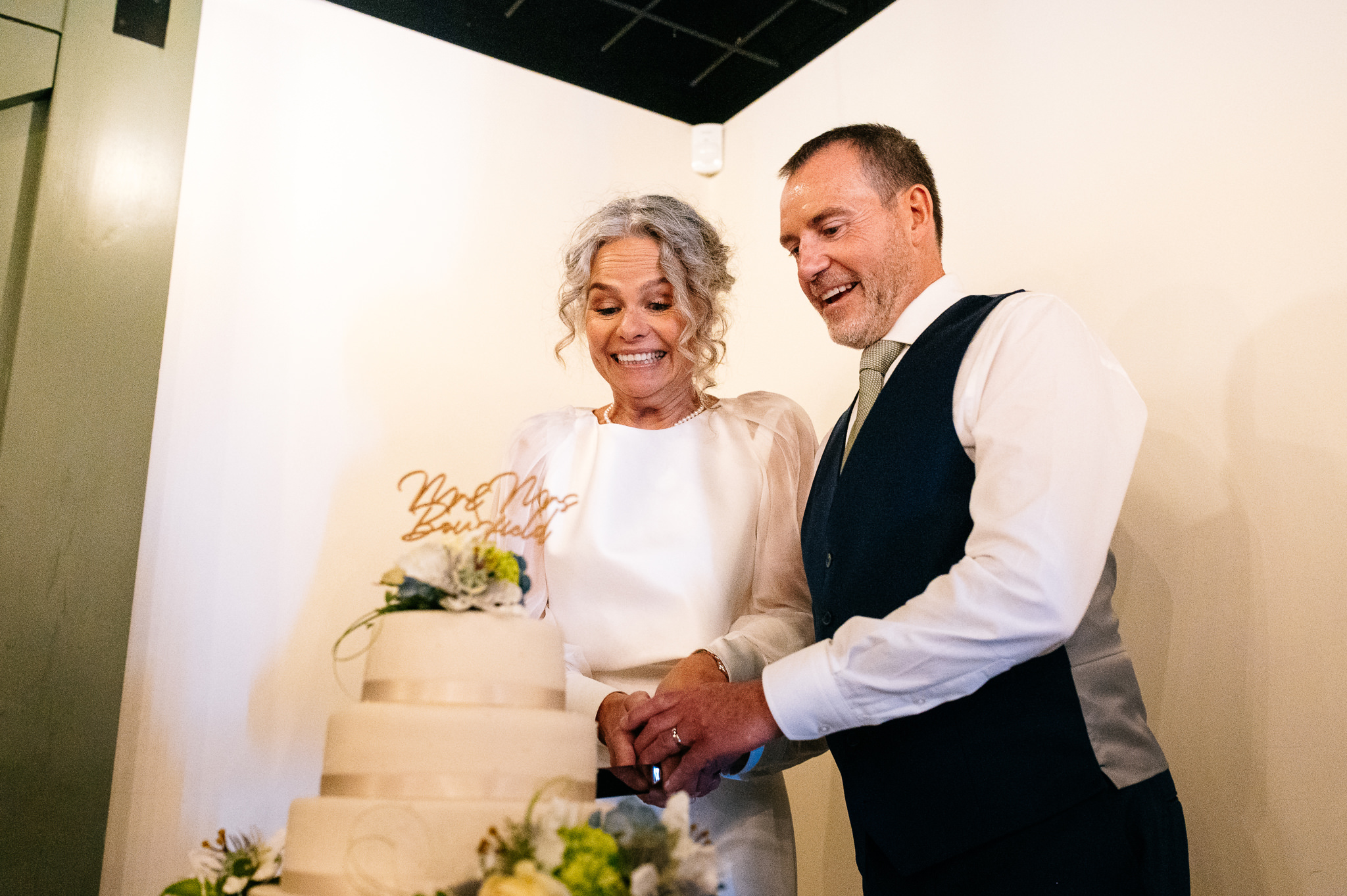 bride and groom cutting the cake at whistle barns