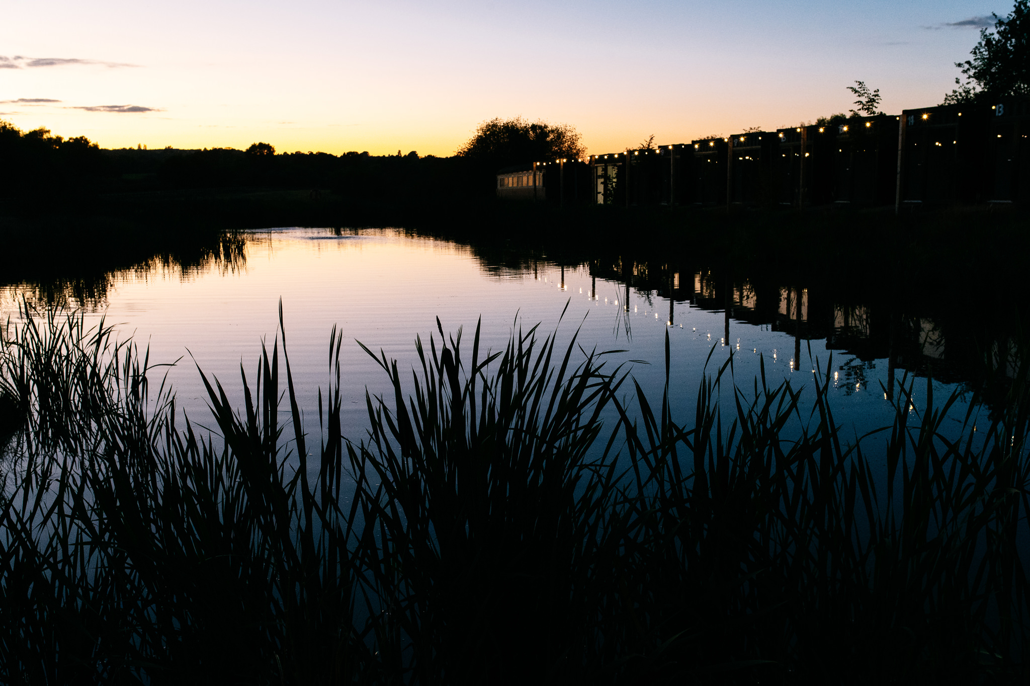 sunset over the water at whistle barns