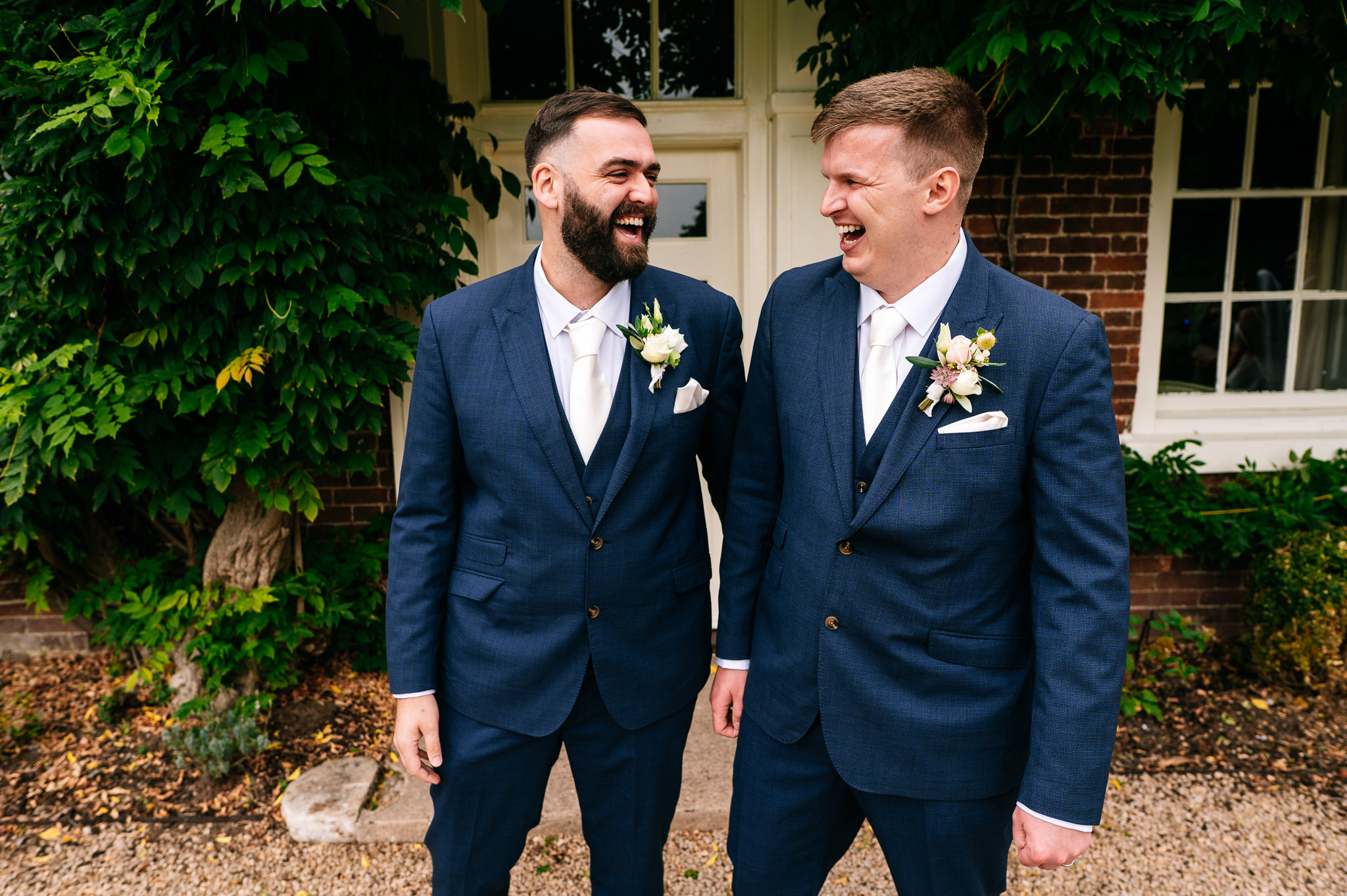 groom and best man stood together laughing