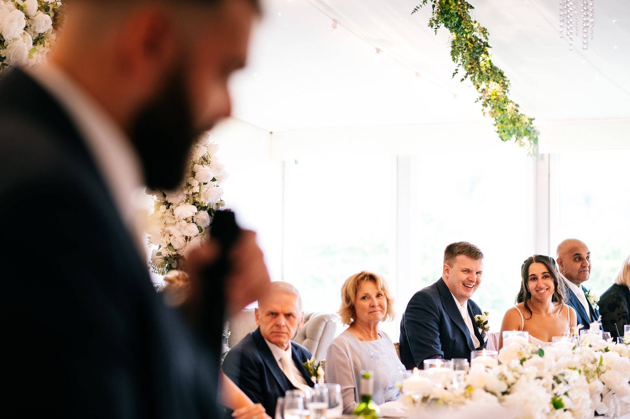 groom laughing during best man's speech