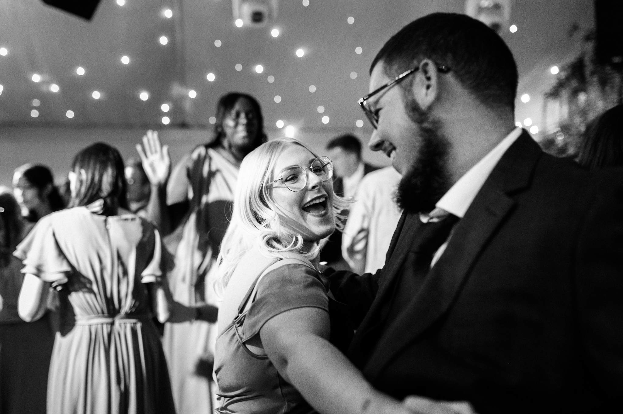 black and white photo of a smiling couple on the dance floor