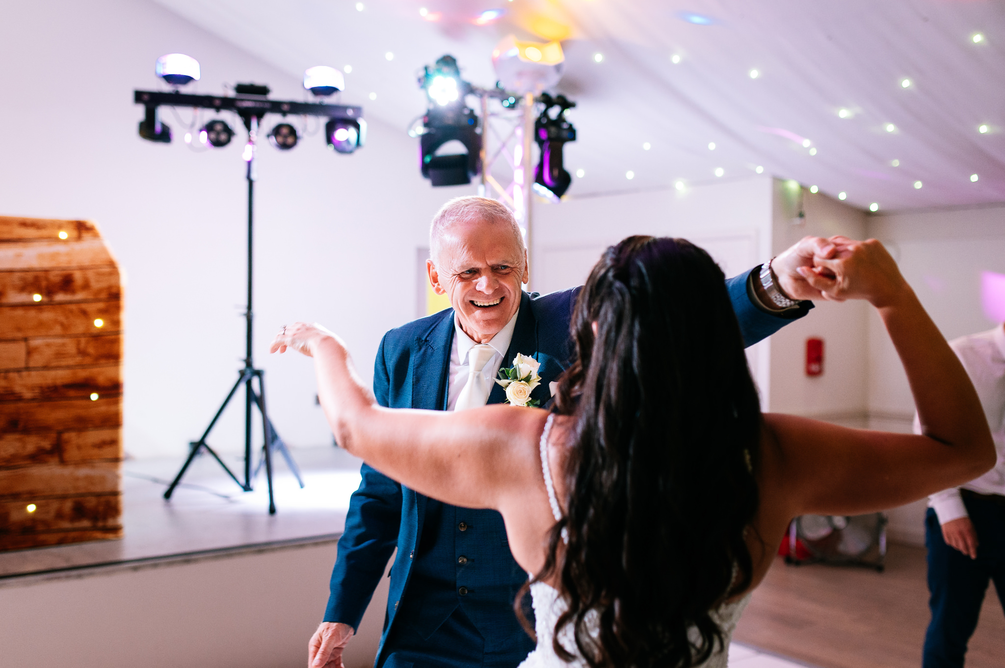father of the groom dancing with the bride