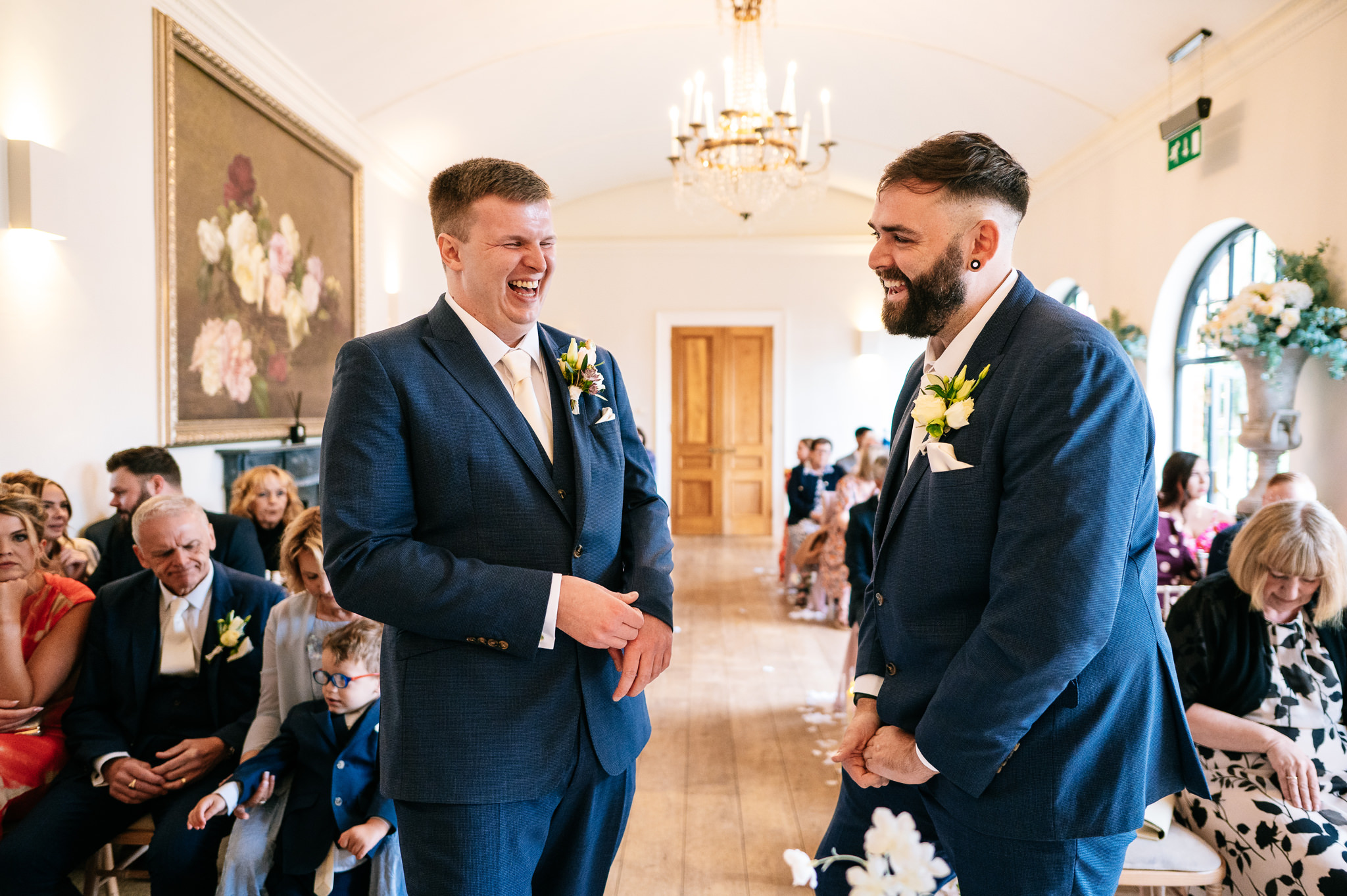 groom and best man share a nervous laugh waiting for the bride to arrive