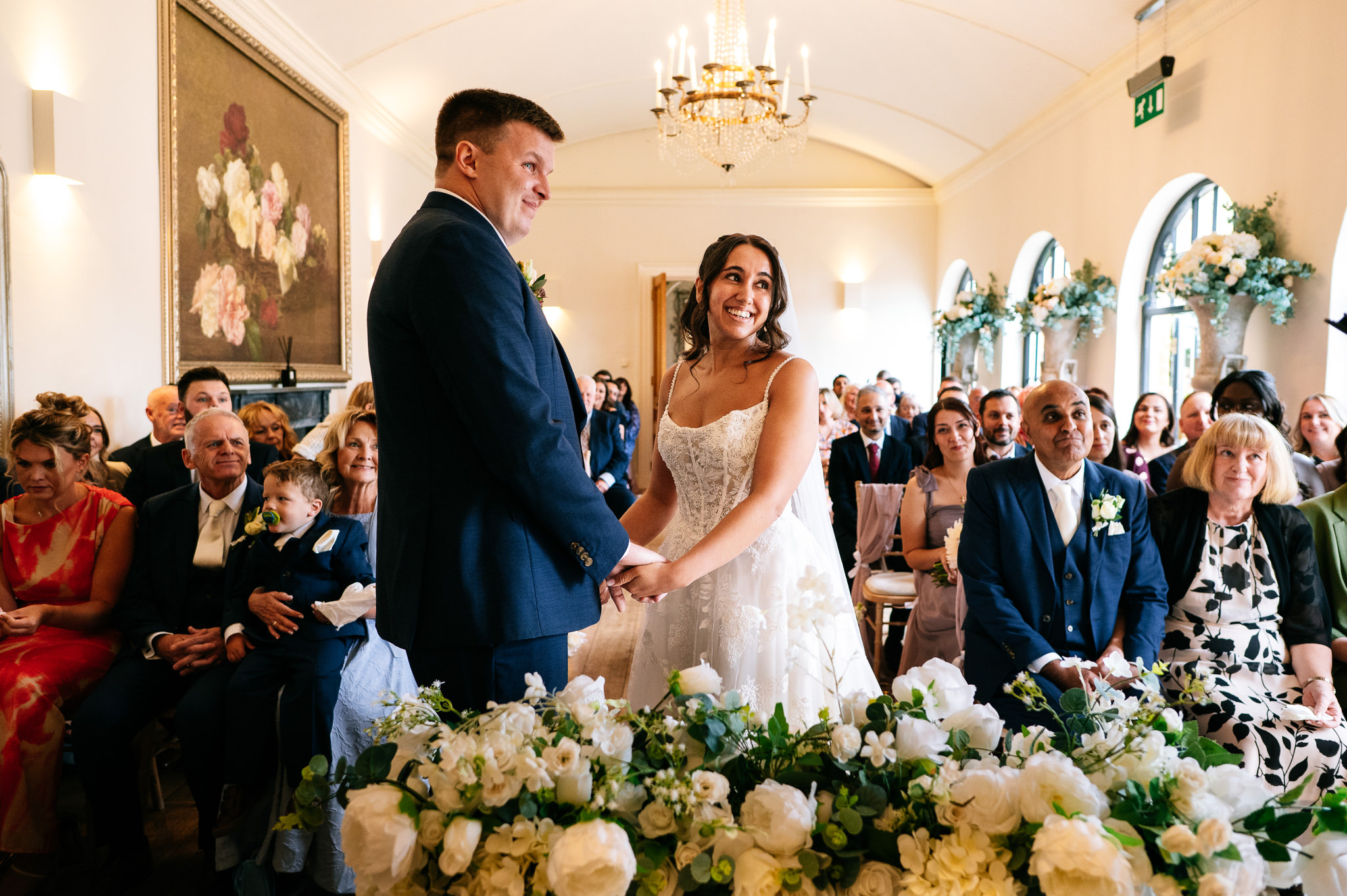 happy bride looks at the registrar as she marries her husband