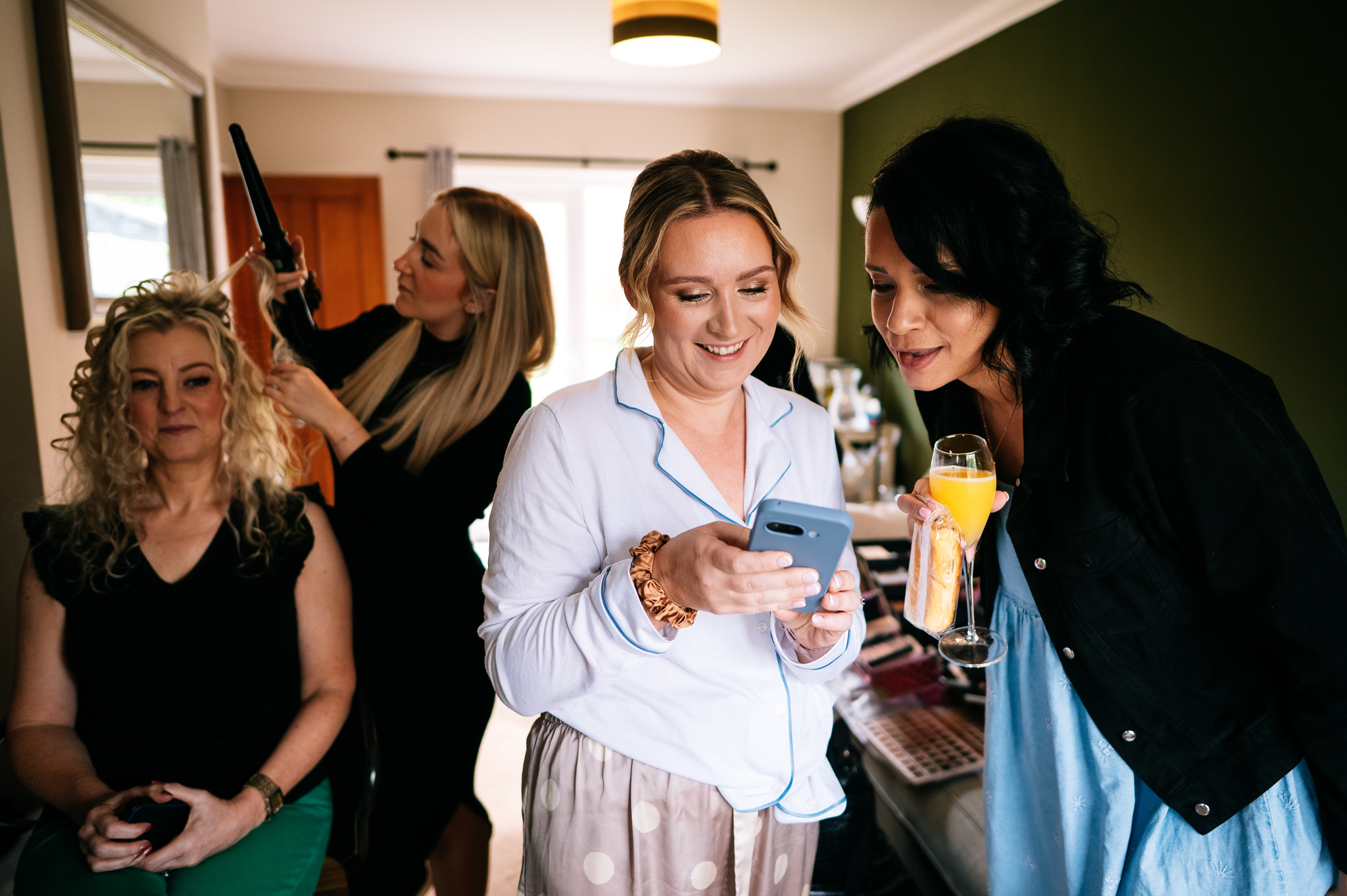 bridesmaids looking at something on a phone