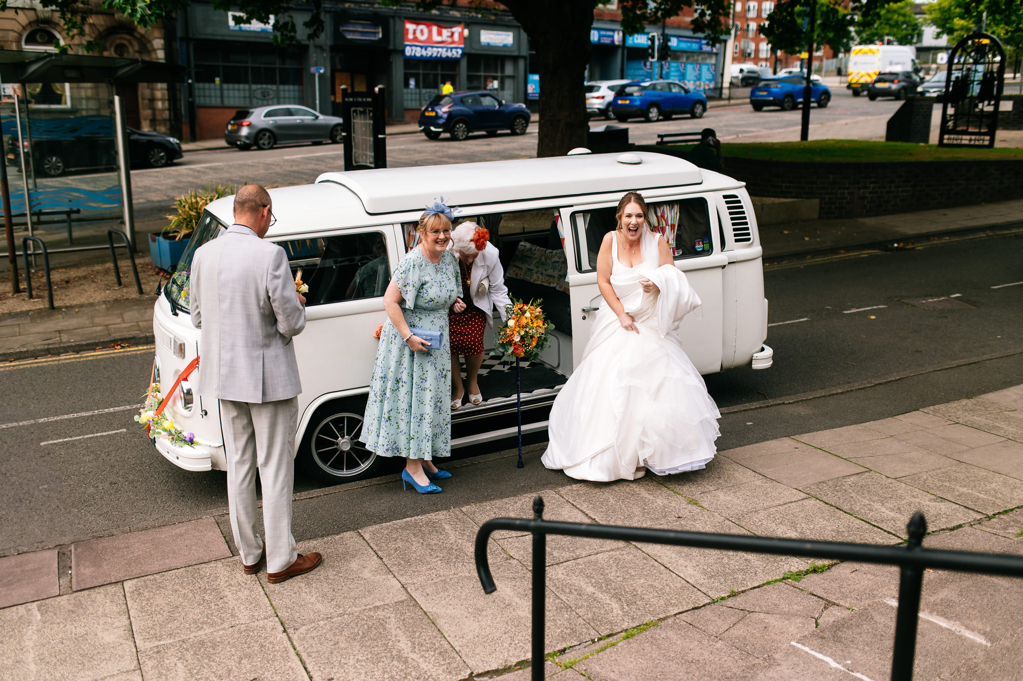 bride arriving in a white vw campervan