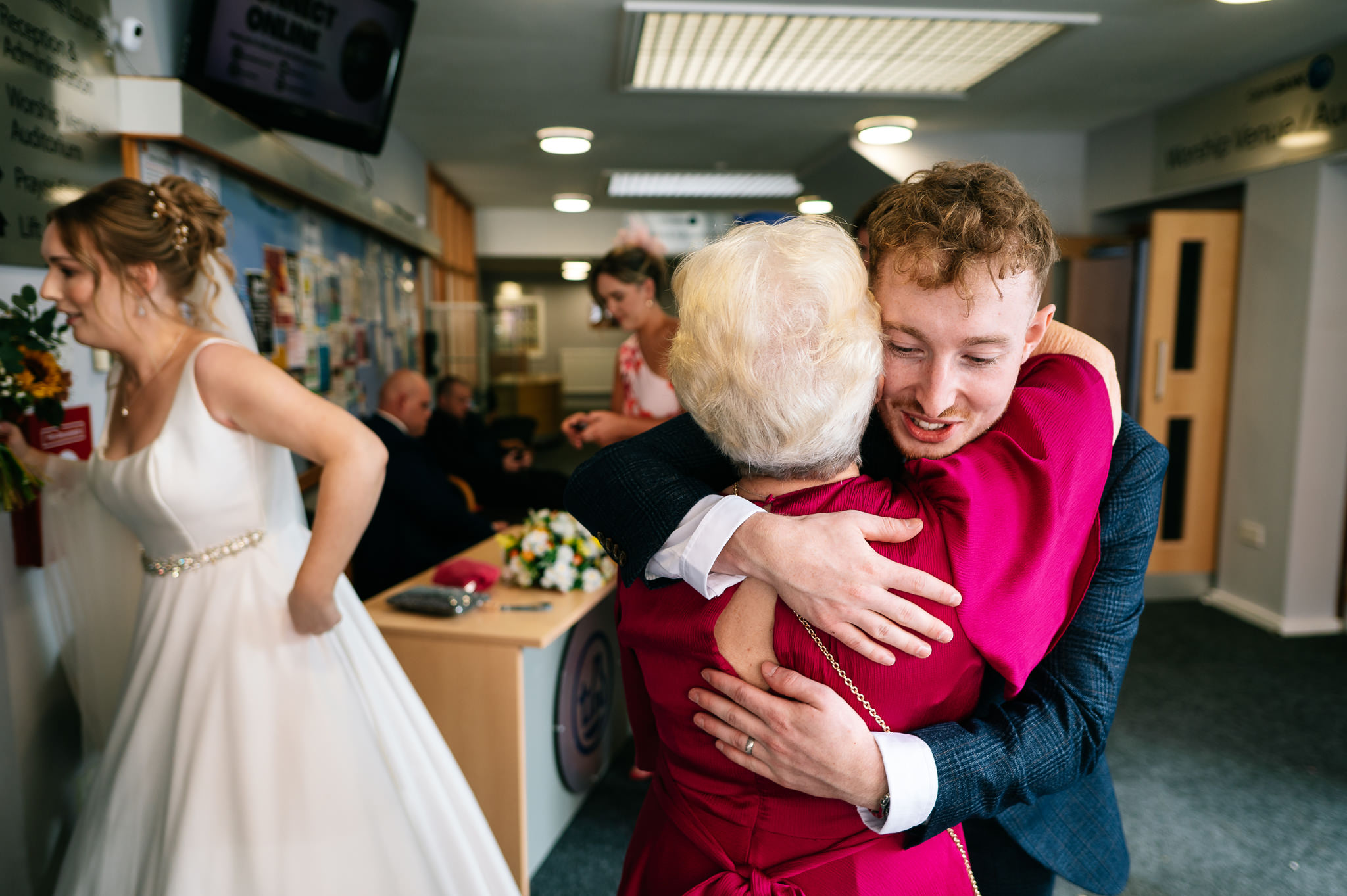 groom hugging a guest