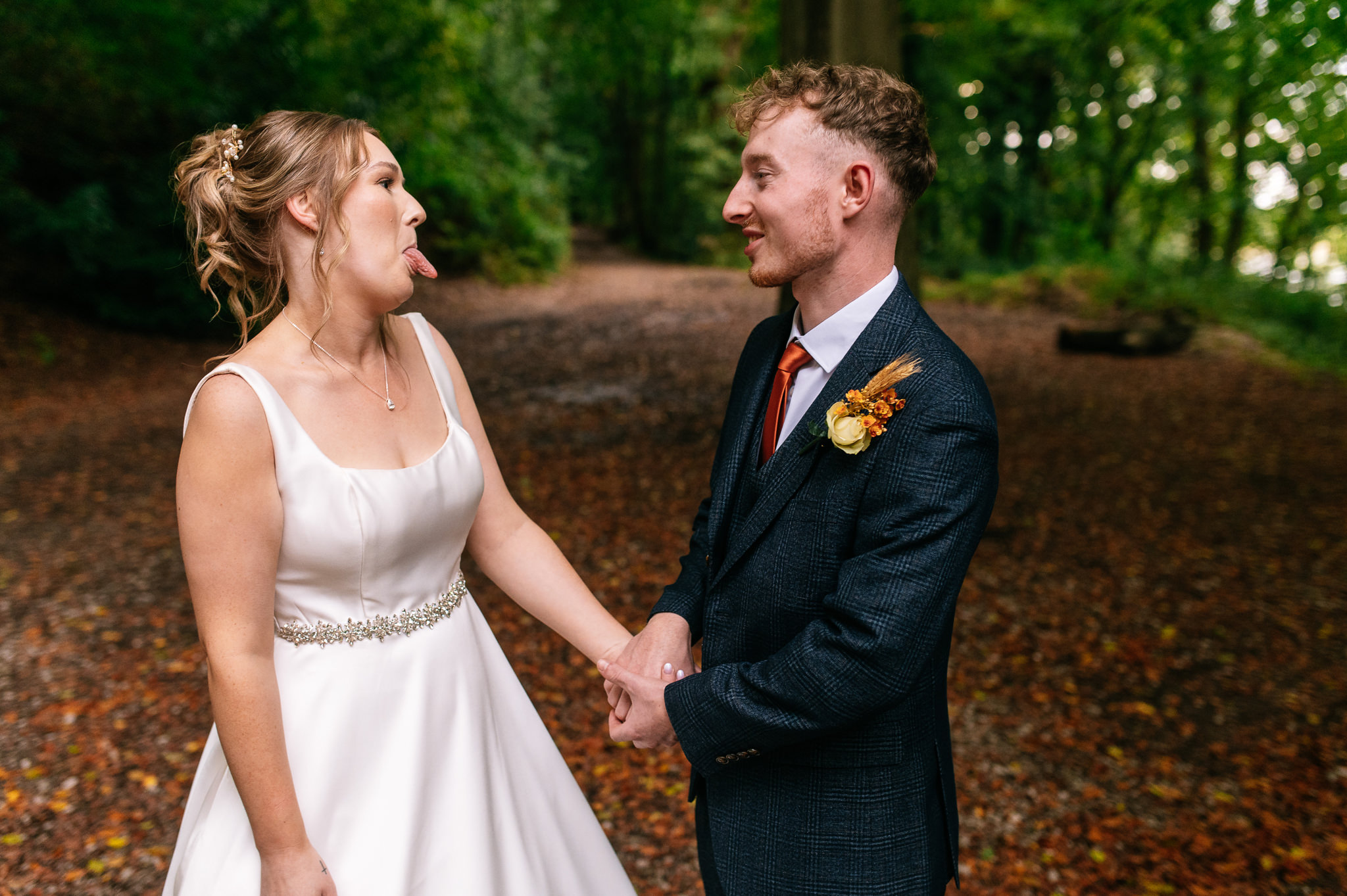 bride sticking her tongue out at her husband during portraits